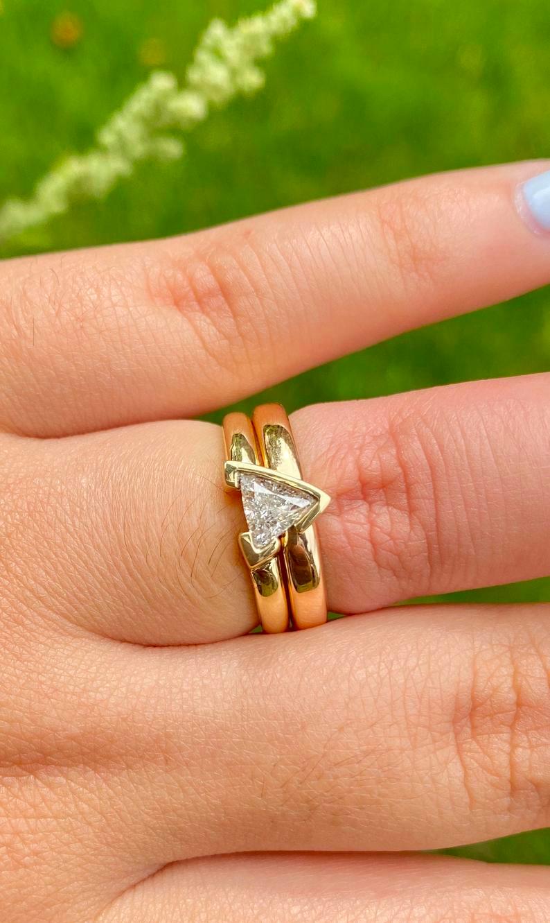 Centering a Trilliant-Cut 0.65 carat Diamond, set in an 18K Yellow Gold Engagement Ring, and stacked by an 18K Yellow Gold Wedding Band,  this engagement ring is the ideal choice for the unique partner. 


Details:
✔ Stackable 2-ring setting
✔