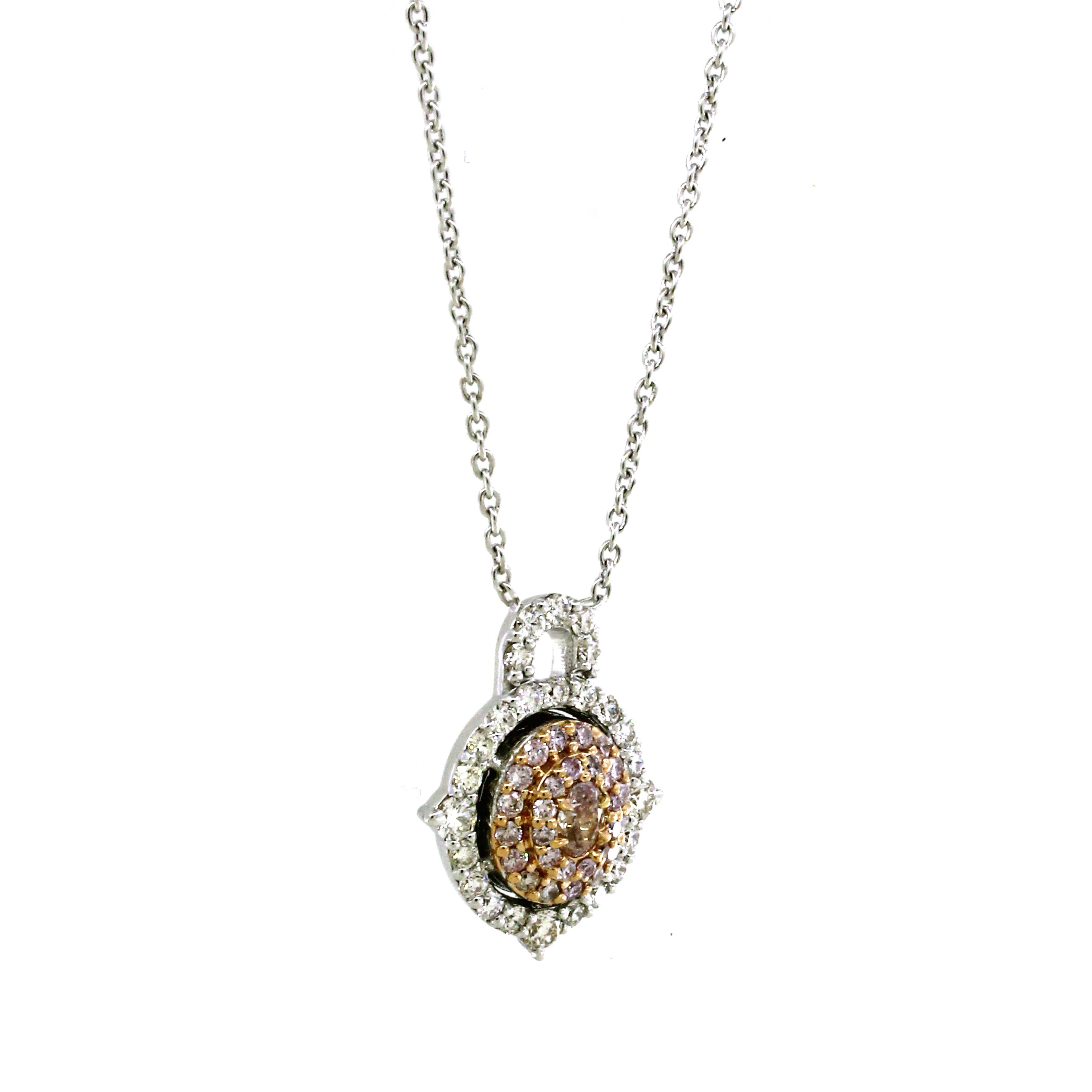 Introducing our Enchanting Petals Pendant, an exquisite adornment crafted in 18k white gold, weighing 4.68 grams. At its core, a radiant fancy pink oval-cut diamond, 0.11 carats, takes center stage, emanating a delicate allure. Embracing this