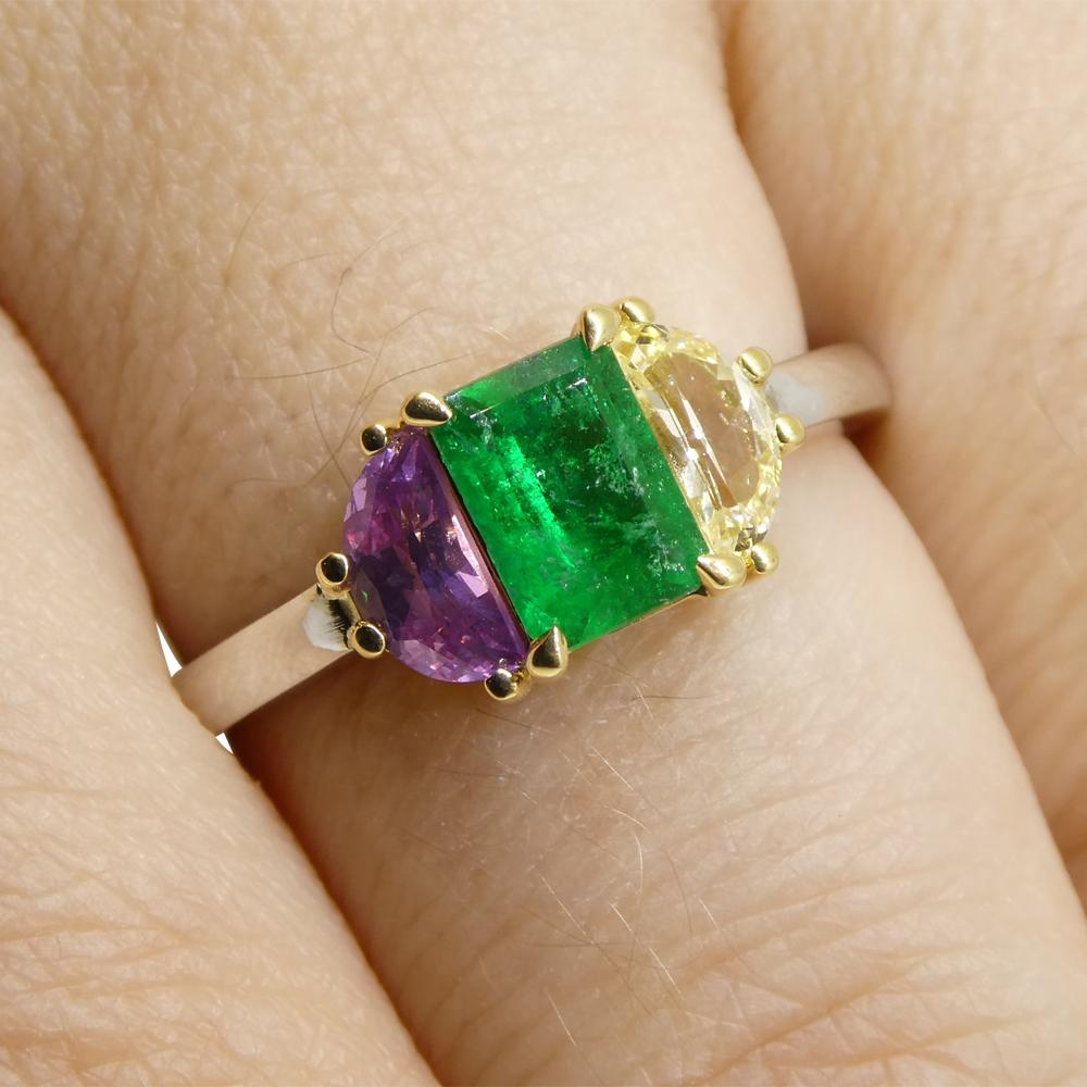This is a stunning Colombian Emerald Ring, set with pink and yellow sapphire in an 18k white and yellow gold setting. 

This ring is made in Toronto, Canada, and is incredibly fine quality!

Gem Type: Emerald
Number of Stones: 1
Weight: 0.65