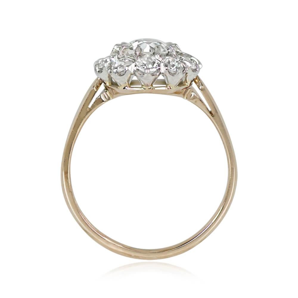 A diamond cluster engagement ring showcasing a central 0.65-carat old European cut diamond, J color, and VS1 clarity, prong-set. Encircling the center stone is a delicate floral halo composed of old European cut diamonds. The additional diamonds,