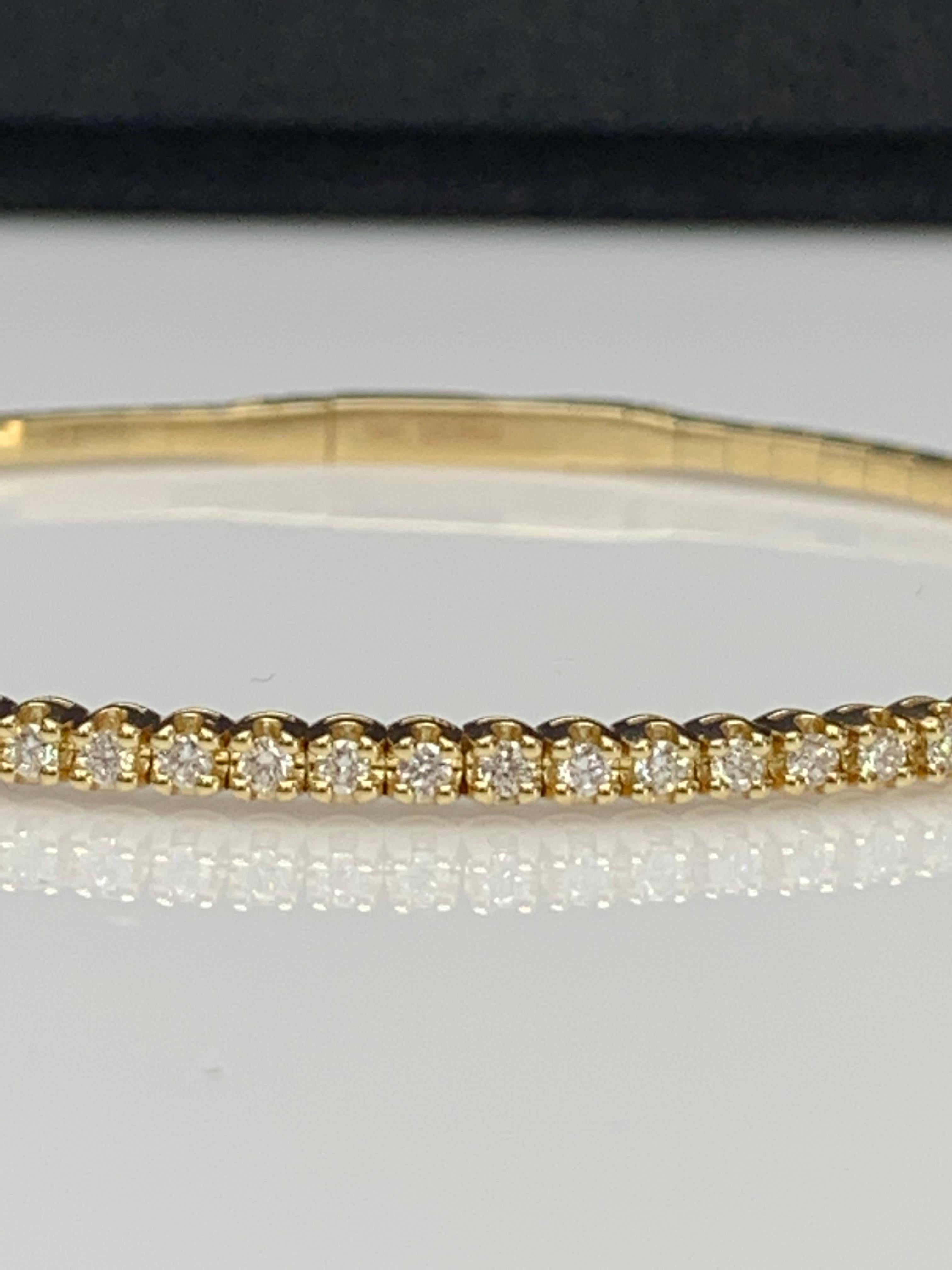 A simple but elegant bangle bracelet set with 33 brilliant round cut diamonds weighing 0.66 carats total. Has a clasp to slip and wear the bangle securely. Made in 14k yellow gold.

Style available in different price ranges. Prices are based on your
