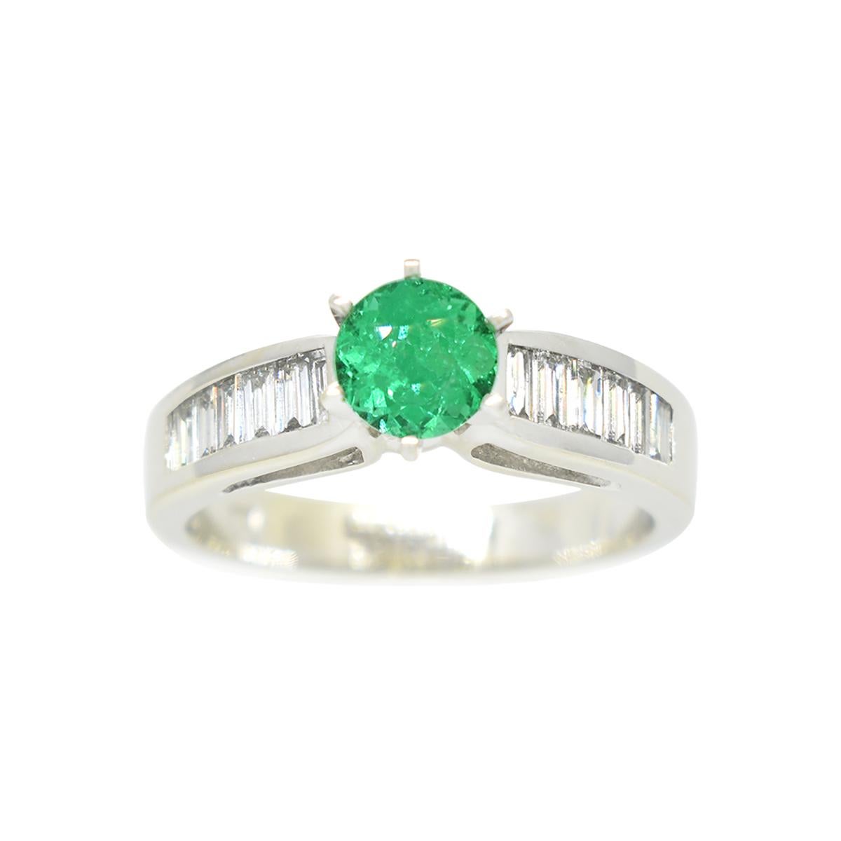 Behold this exquisite Emerald and Diamond Engagement Ring, a true symbol of everlasting love and commitment. Crafted in gleaming 14K white gold, it features a captivating 0.66 Carat round-cut natural Colombian emerald at its heart, surrounded by the