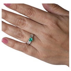 0.66 Carats Emerald Engagement Ring in White Gold With Baguette Cut Diamonds