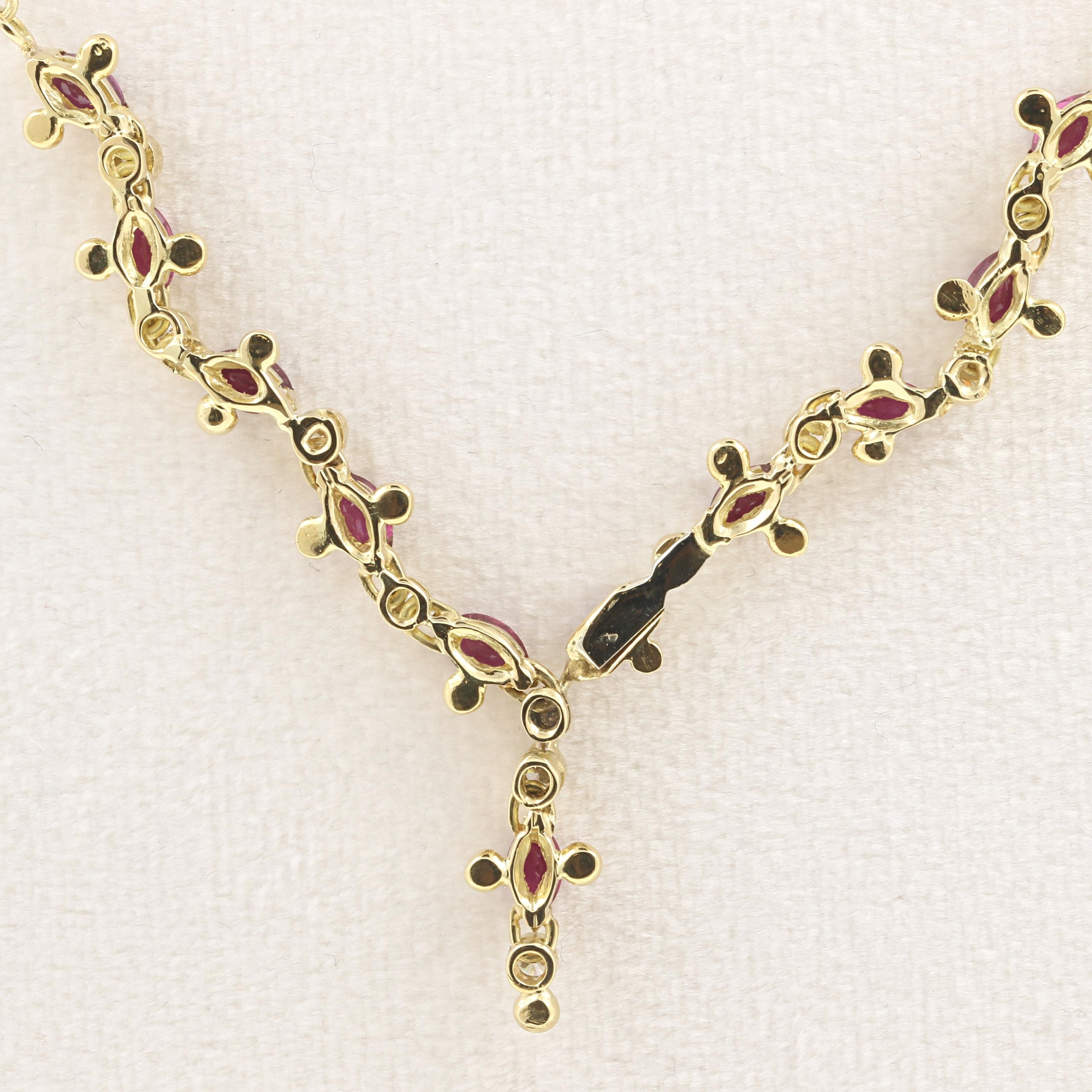 This suggestive 18K yellow gold necklace with a central motive made of oval rubies and round brilliant diamonds reminds of a typical Sardigna Island goldsmith technique. 
The central part alternates rubies with diamonds, for a joyful decorative