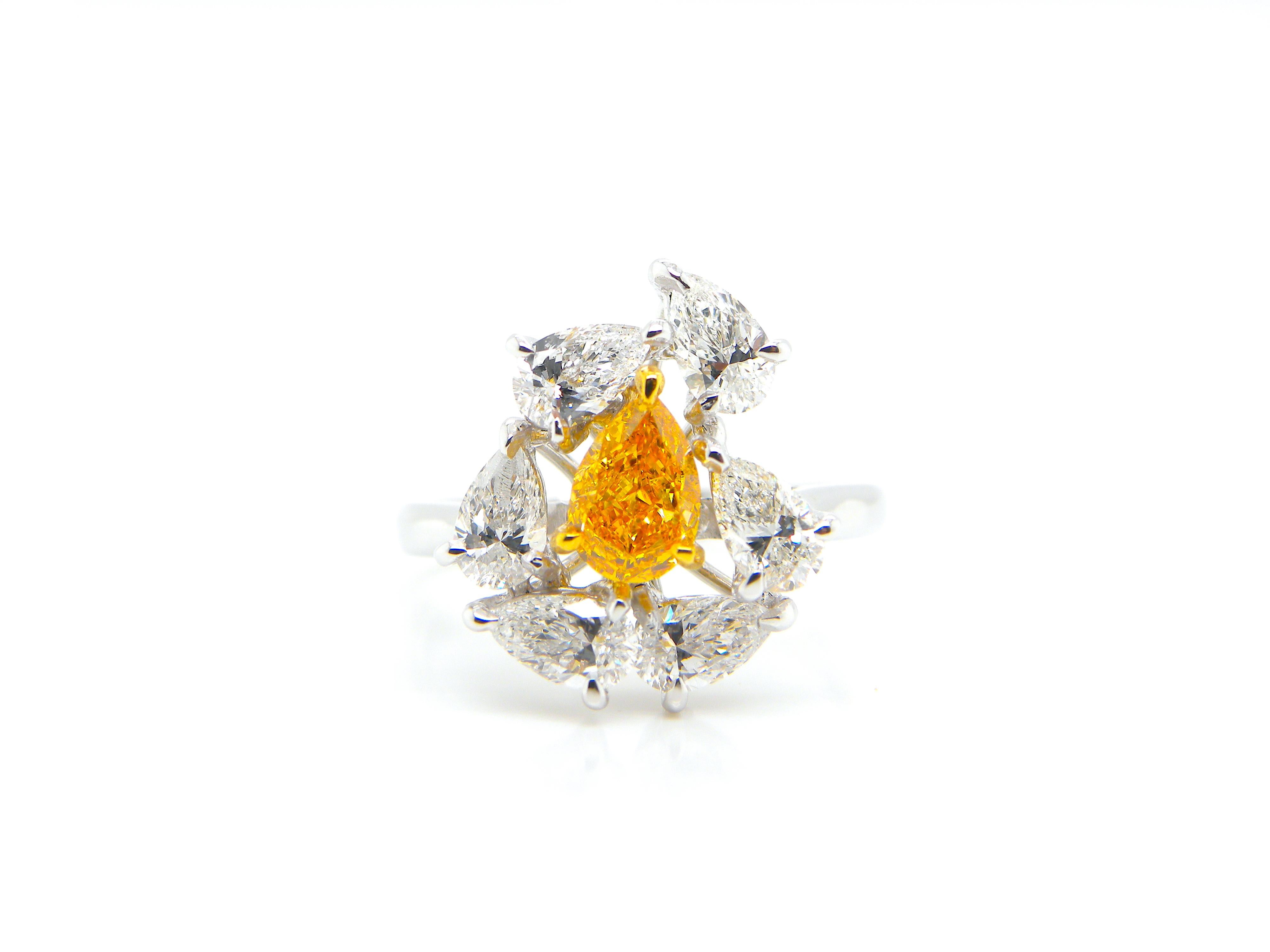 0.67 Carat GIA Certified Fancy Vivid Yellow-Orange Diamond and White Diamond Ring:

An extremely rare jewel, it features a 0.67 carat GIA certified fancy vivid yellow-orange pear-shaped diamond surrounded by a flurry of super-white oval and