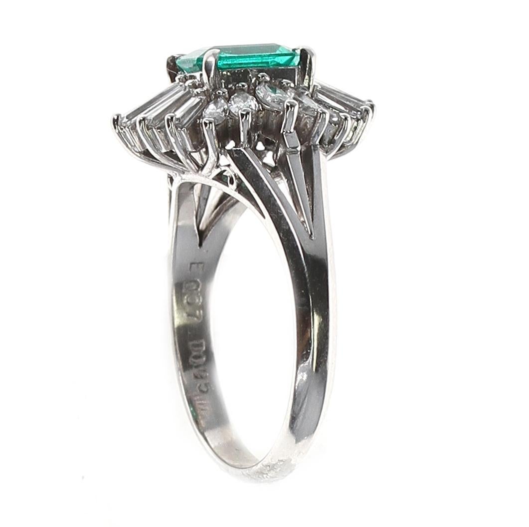 A 0.67 Carat Rectangular Emerald-Cut Emerald and Diamond Cocktail Ring made in Platinum. Diamond Weight: 0.95 carats. Total Weight: 7.22 grams. 

1-ARTEJAYU