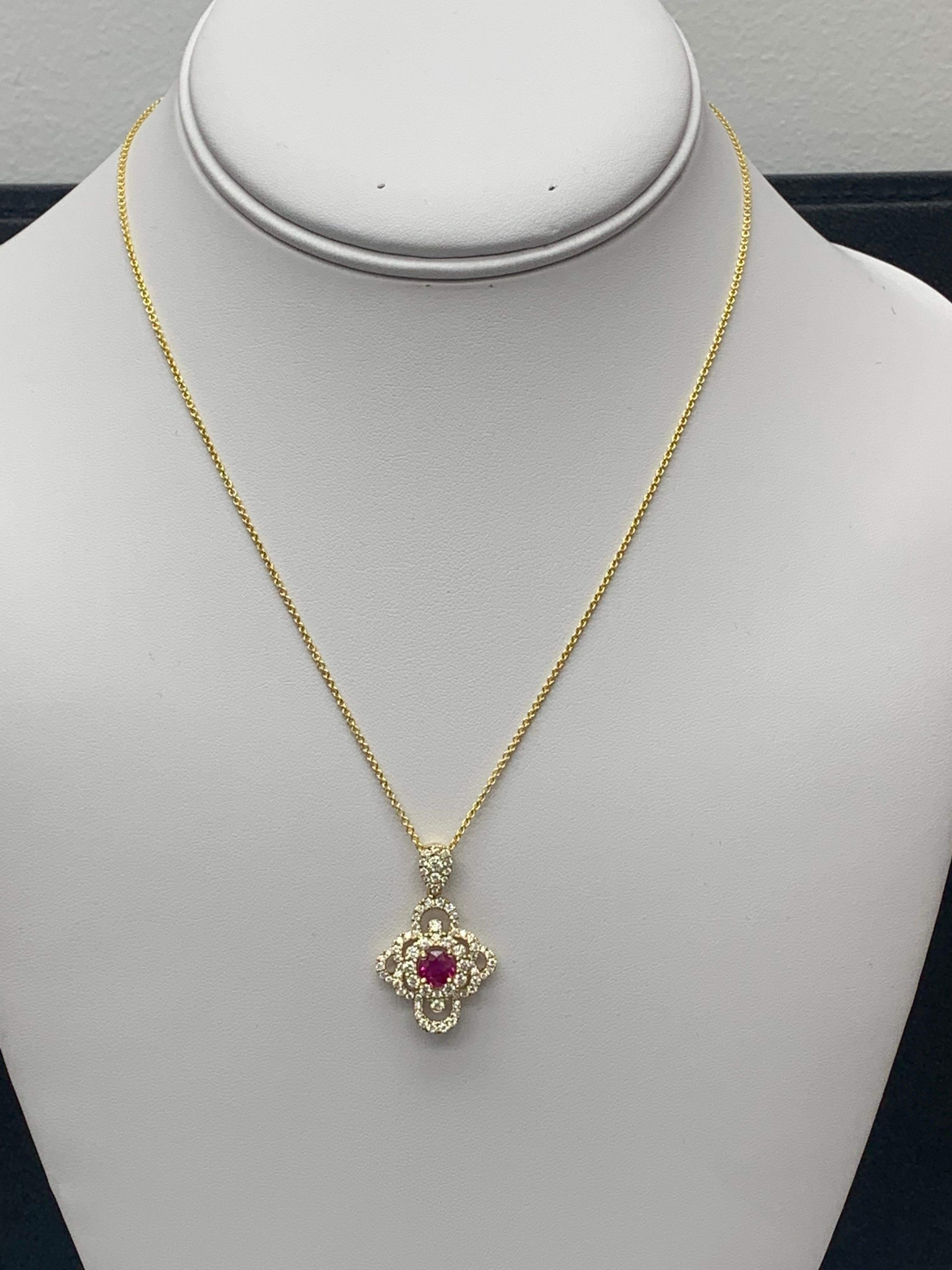 A Classic pendant necklace Set with a round ruby center stone accented by 76 accent brilliant diamonds in an open work design. The weight of diamonds and ruby is 1.03 carats and 0.71 carats respectively. 16