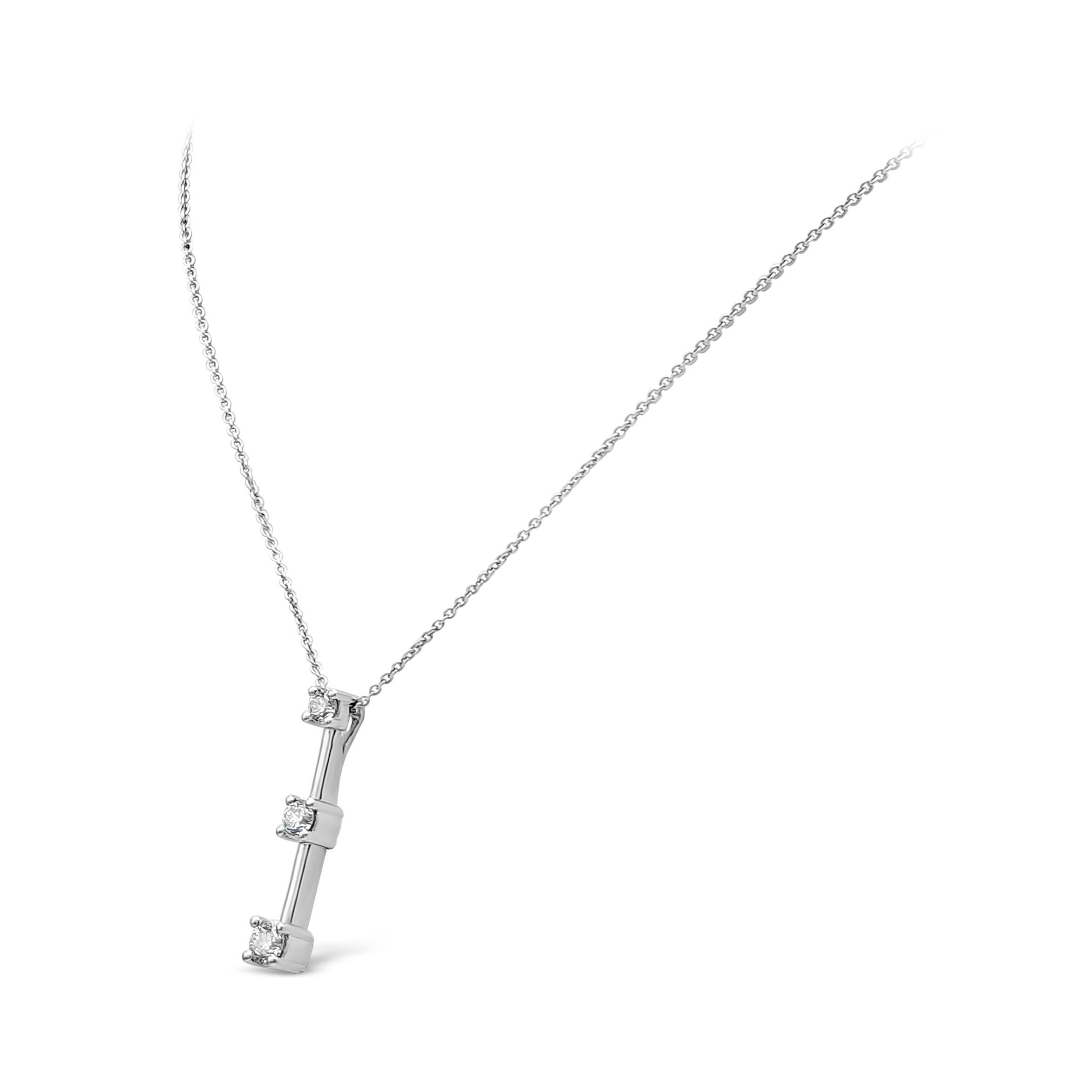 A simple modern drop pendant necklace showcasing three dazzling brilliant round diamonds weighing 0.67 carat total, G in Color and VS-SI in Clarity. Set in a classic 4 prong setting. Made with 18K White Gold, 14k chain 18 inches in Length. 

Style