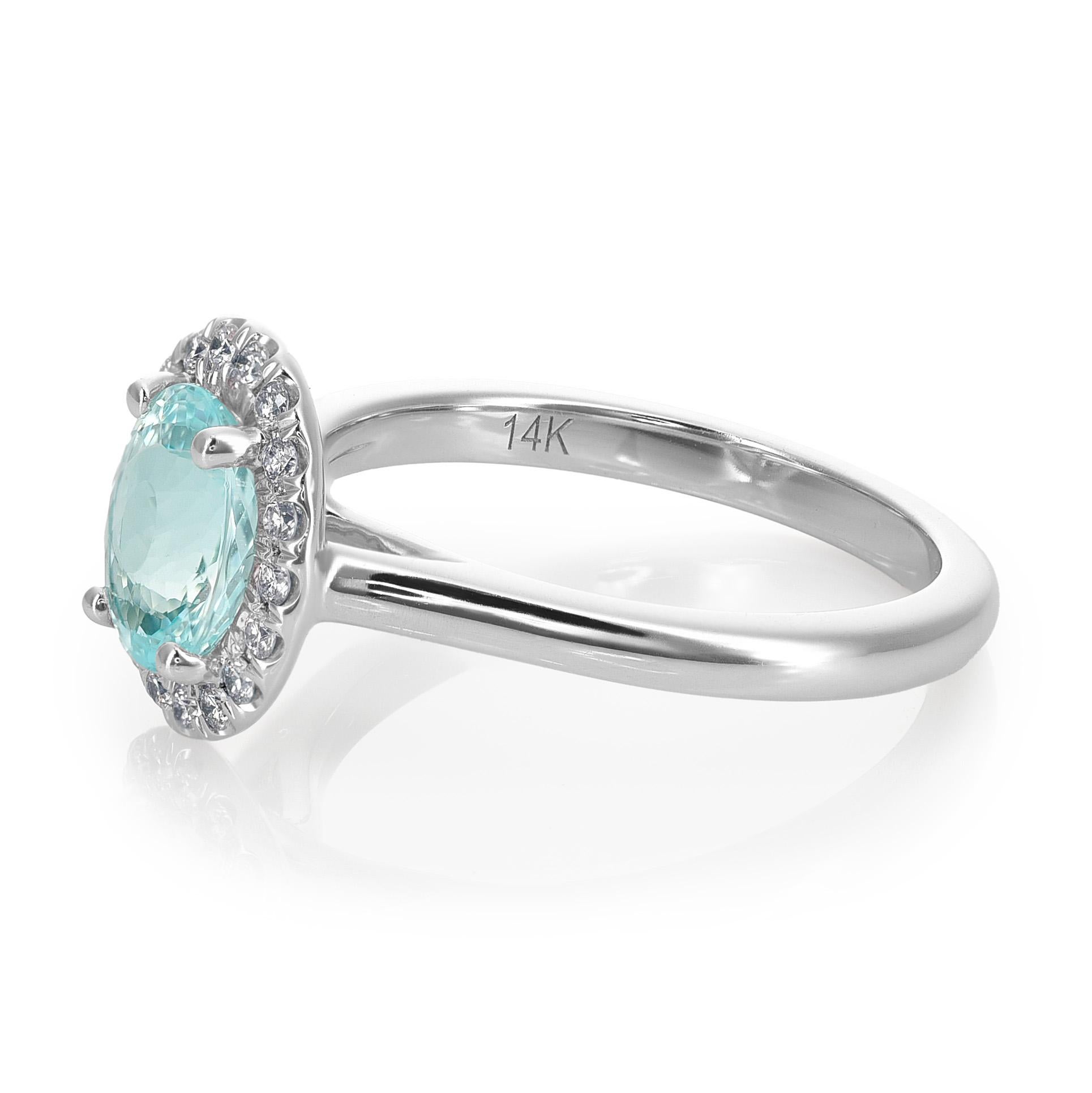 Immerse yourself in the allure of this 14K White Gold Ring, adorned with a 0.67 carats Natural Paraiba Tourmaline in an elegant oval shape. The vibrant blue-green hues of the Paraiba Tourmaline are enhanced through a meticulous heating process,
