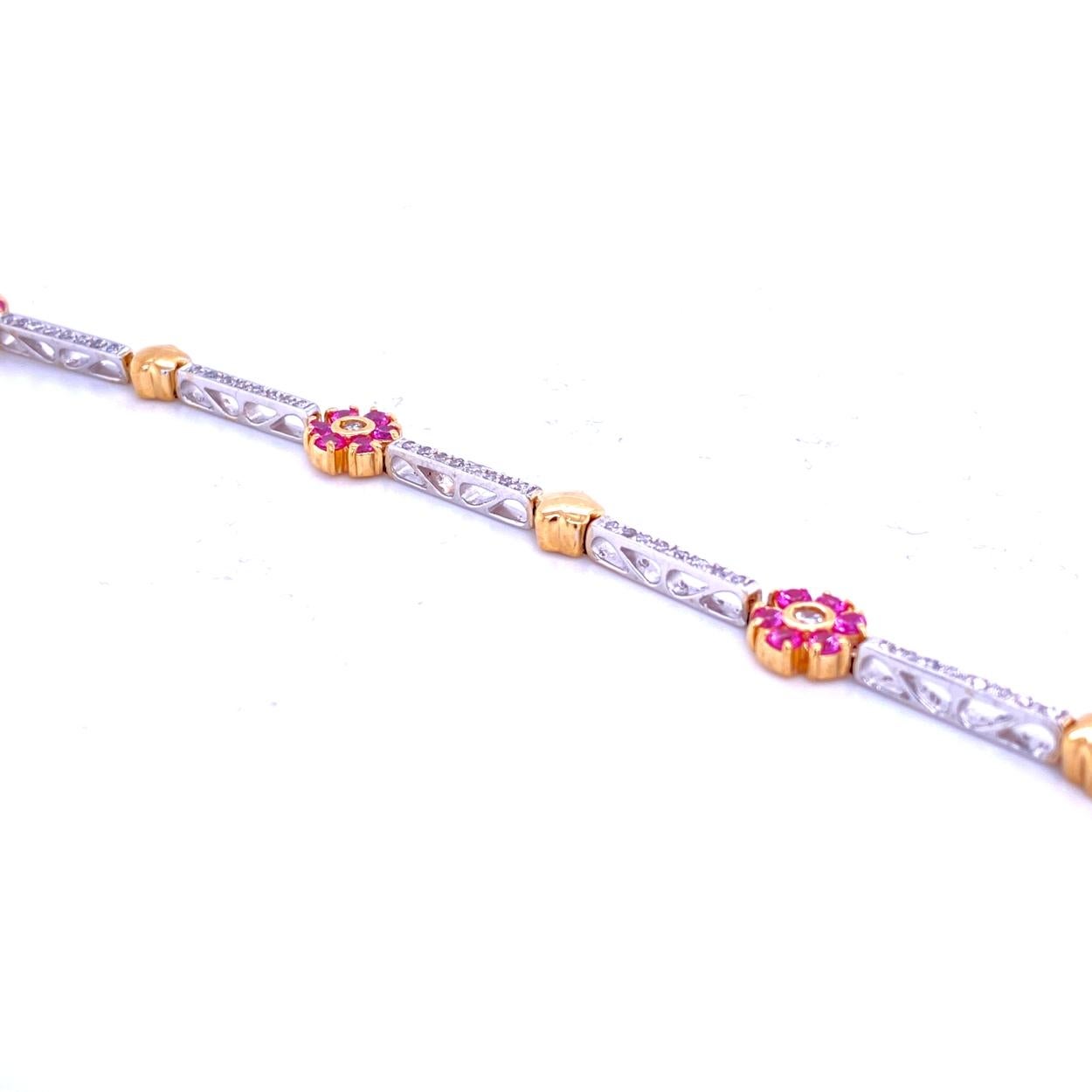 This Diamond/Pink Sapphire Bracelet consists of 7 Pave Set Bar Links, 4 Pick Sapphire Round Clusters with diamond center and 4 Yellow Gold Stars.  The bracelet is made in 14K Two tone Gold with total of 0.67 Ct Round Brilliant diamonds and 1.59 Ct