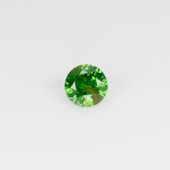 0.67 ct, Vivid green faceted Russian demantoid with byssolite inclusioms