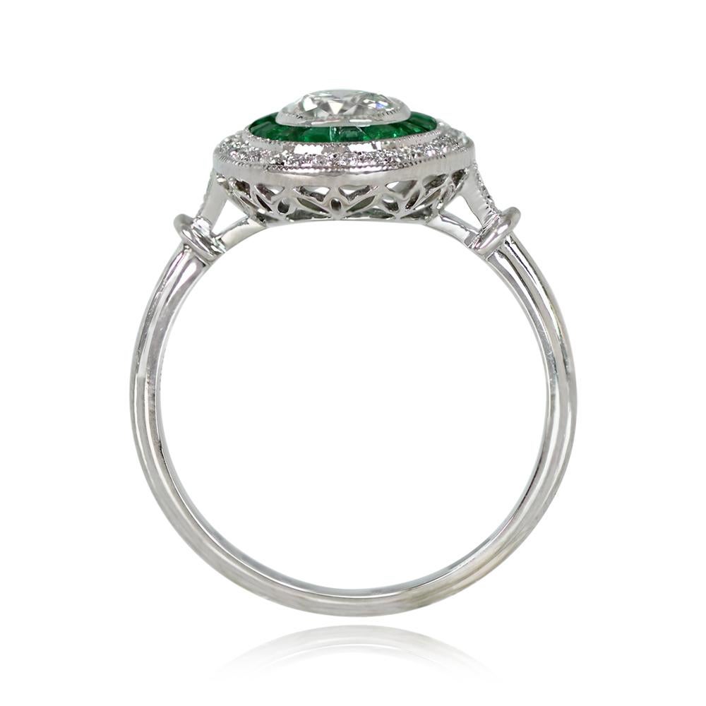 A stunning double halo engagement ring showcases a bezel-set antique cushion cut diamond, about 0.67 carats, with J color and VS2 clarity. The center stone is encircled by emeralds, and enveloped by an oval-shaped halo of diamonds.

Ring Size: 6.5