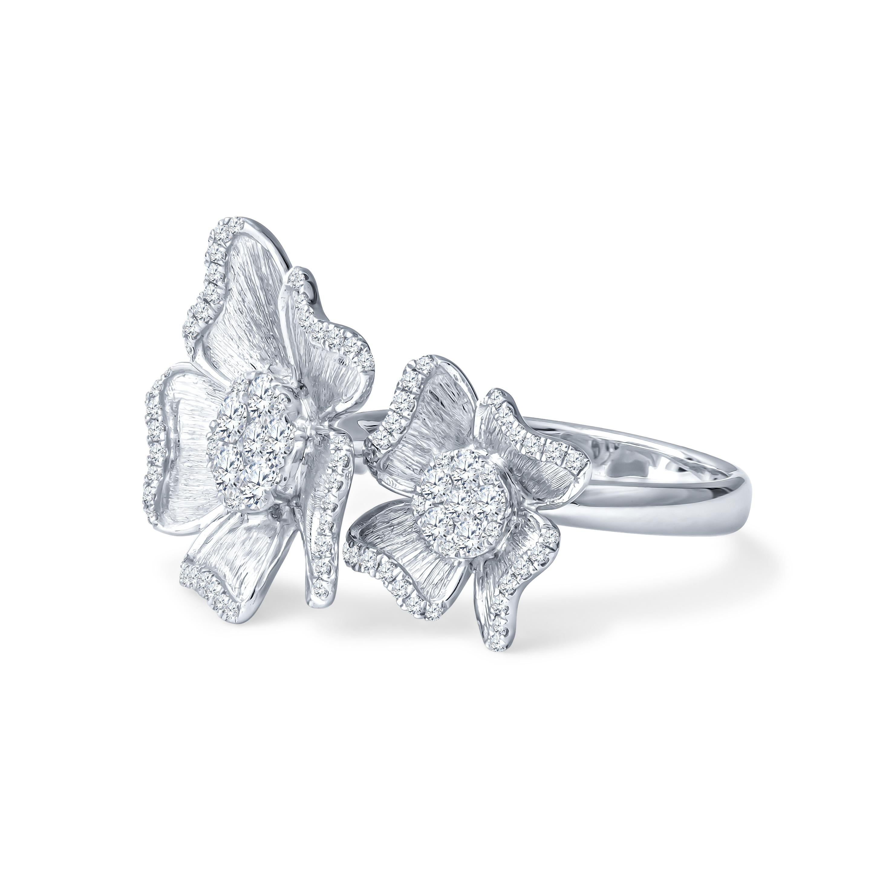 This exquisite ring is a stunning 0.67ctw in round cut diamonds, adorning two 18kt white gold flowers. It is a size 6.5 ring, but can be resized upon request. 