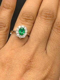 0.68 Carat Oval Cut Emerald and Diamond Ring in 18k White Gold
