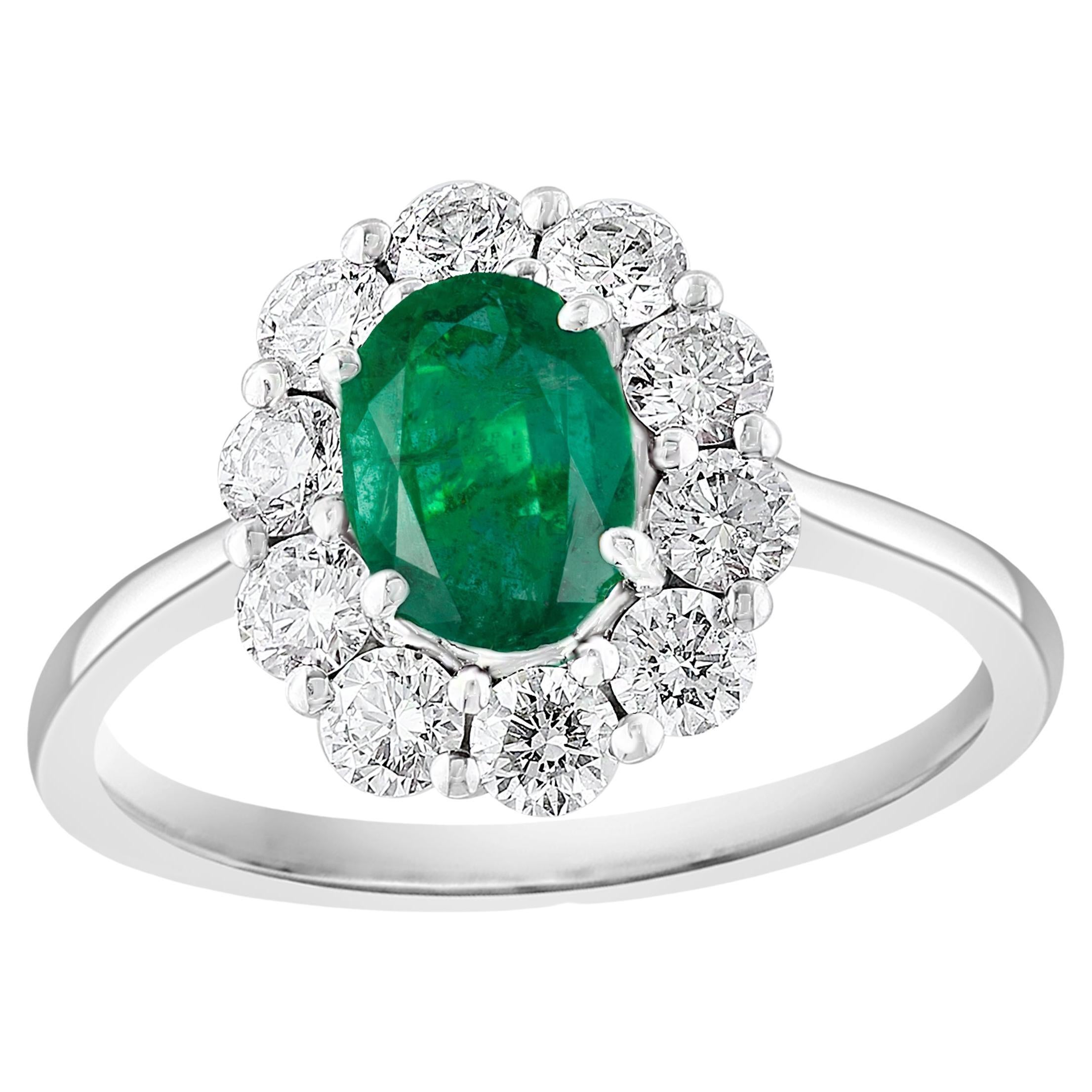 0.68 Carat Oval Cut Emerald and Diamond Ring in 18k White Gold For Sale