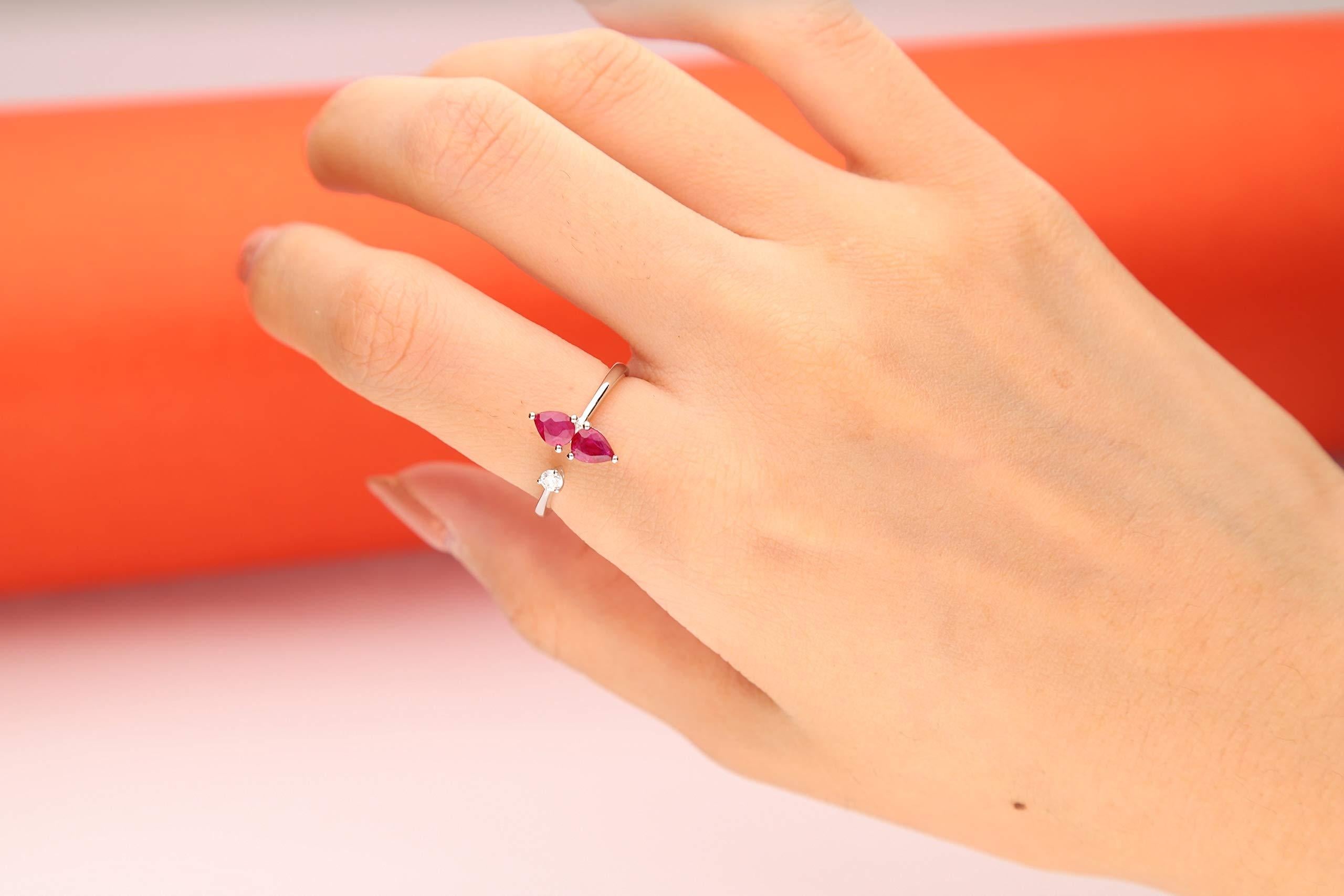 Decorate yourself in elegance with this Ring is crafted from 18-karat White Gold by Gin & Grace. This Ring is made up of Pear-Cut Ruby (2 pcs) 0.68 carat and Round-cut White Diamond (1 Pcs) 0.07 Carat. This Ring is weight 2.21 grams. This delicate