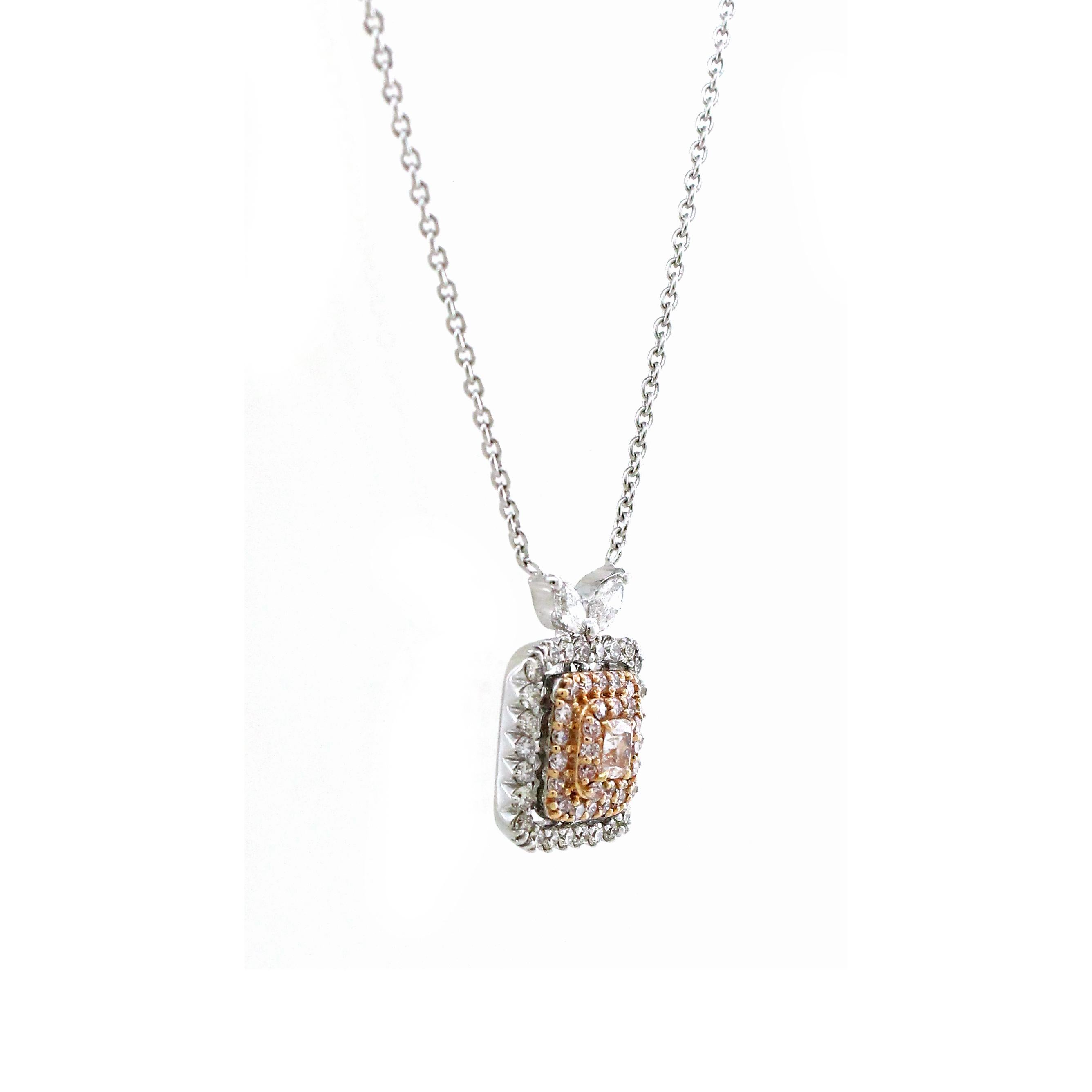 Prepare to be captivated by the sheer magnificence of this exquisite pendant, a true marvel of jewelry craftsmanship. At its core, a resplendent 0.13-carat pink cushion diamond emanates a radiant, blushing beauty. Surrounding this precious gem, two