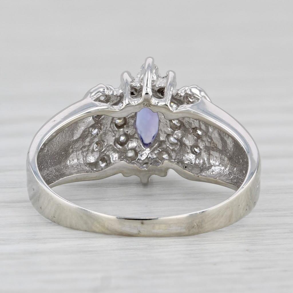 Gemstone Information:
- Natural Tanzanite -
Carats - 0.35ct
Cut - Marquise
Color - Purple
Treatment - Heated

- Natural Diamonds -
Total Carats - 0.33ctw
Cut - Round Brilliant
Color - H - I
Clarity - I1 - I2

Metal: 14k White Gold
Weight: 3.3 Grams