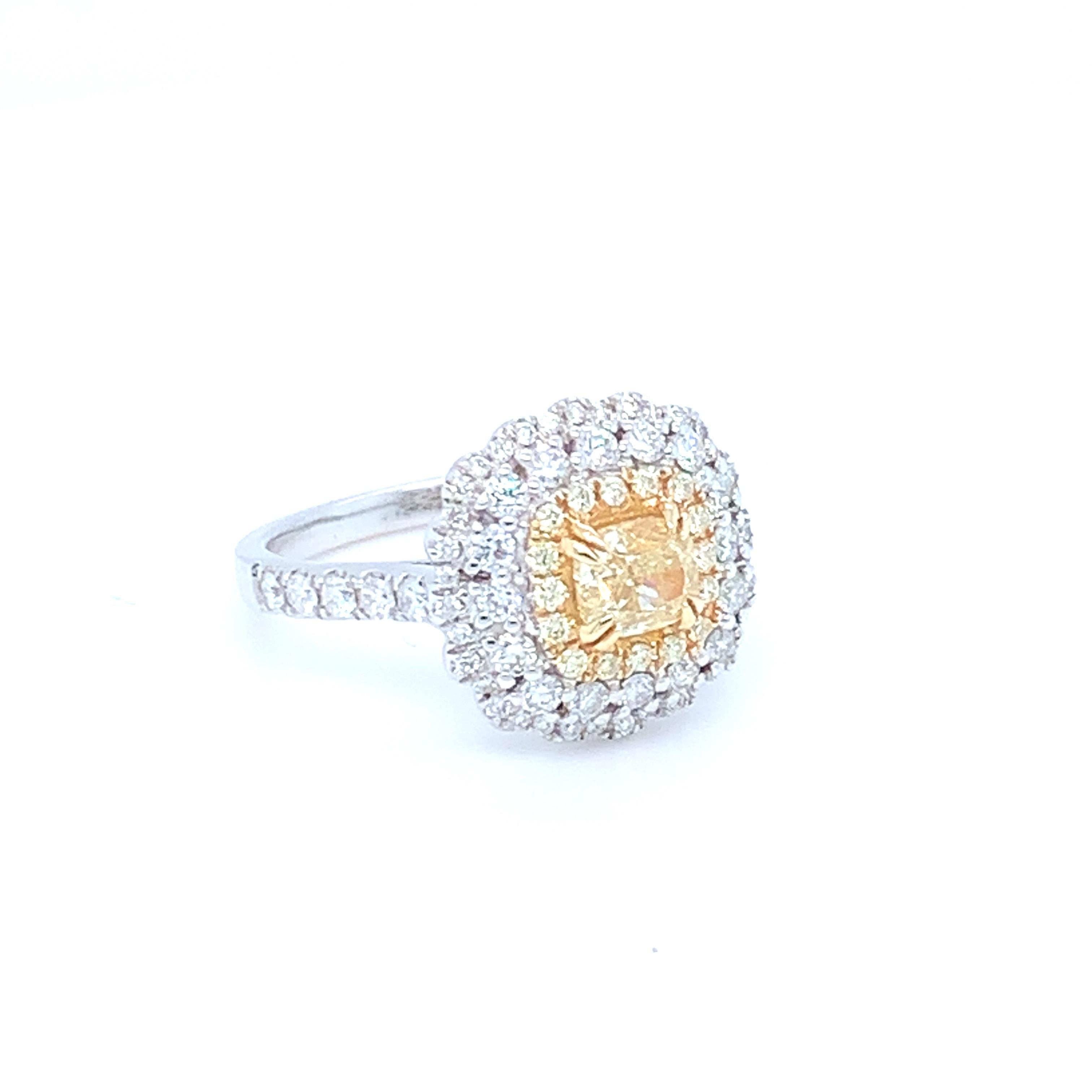 This lovely halo ring features a center yellow diamond. Set in two tone gold to match the two tone diamond settings. This piece has been crafted by hand to achieve the finest quality. 
Center diamond: 0.69ct
Yellow diamond: 0.10ct
White diamond;