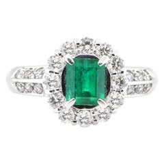 0.69 Carat Natural Emerald and Diamond Engagement Ring Set in Platinum