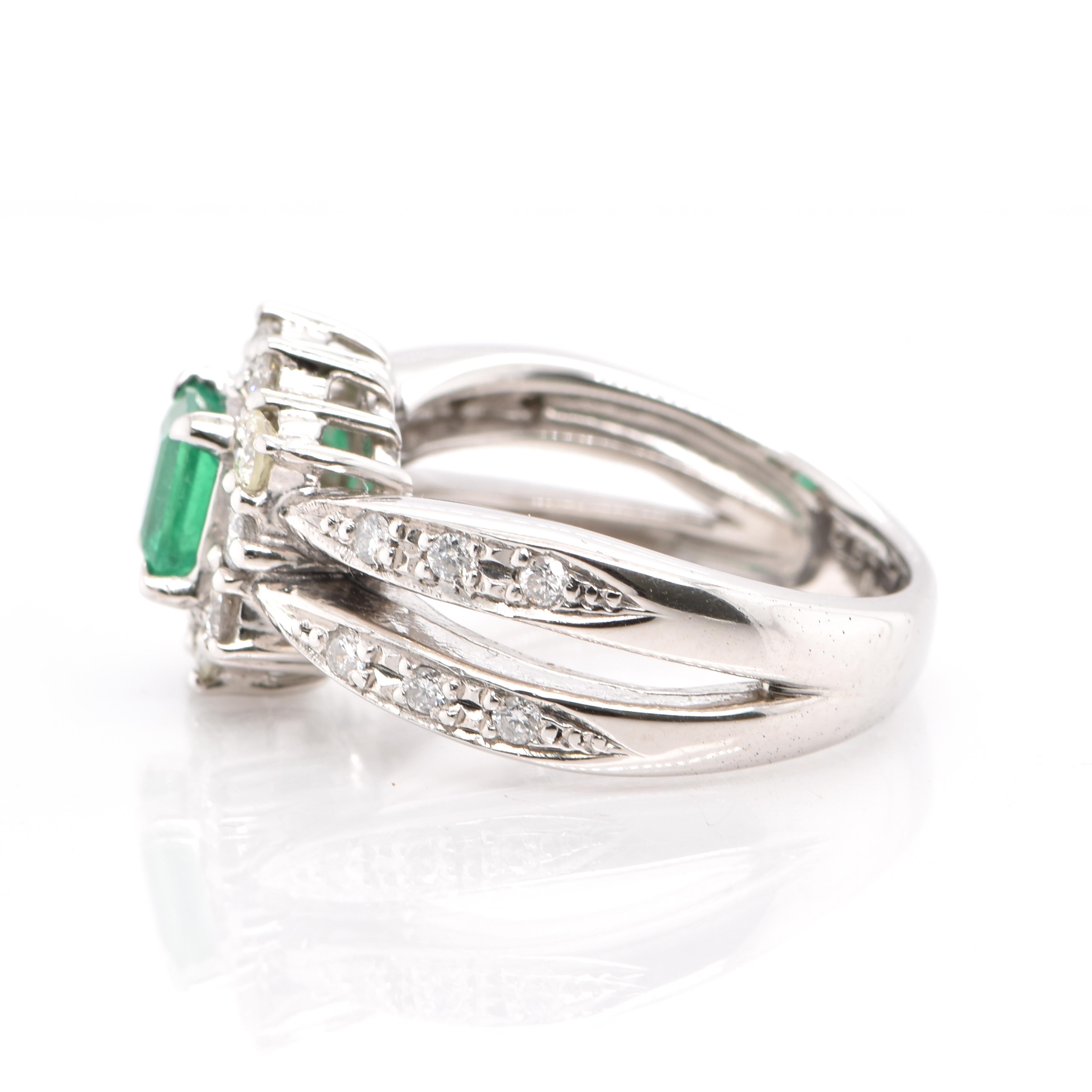 Emerald Cut 0.69 Carat Natural Emerald and Diamond Ring Set in Platinum For Sale