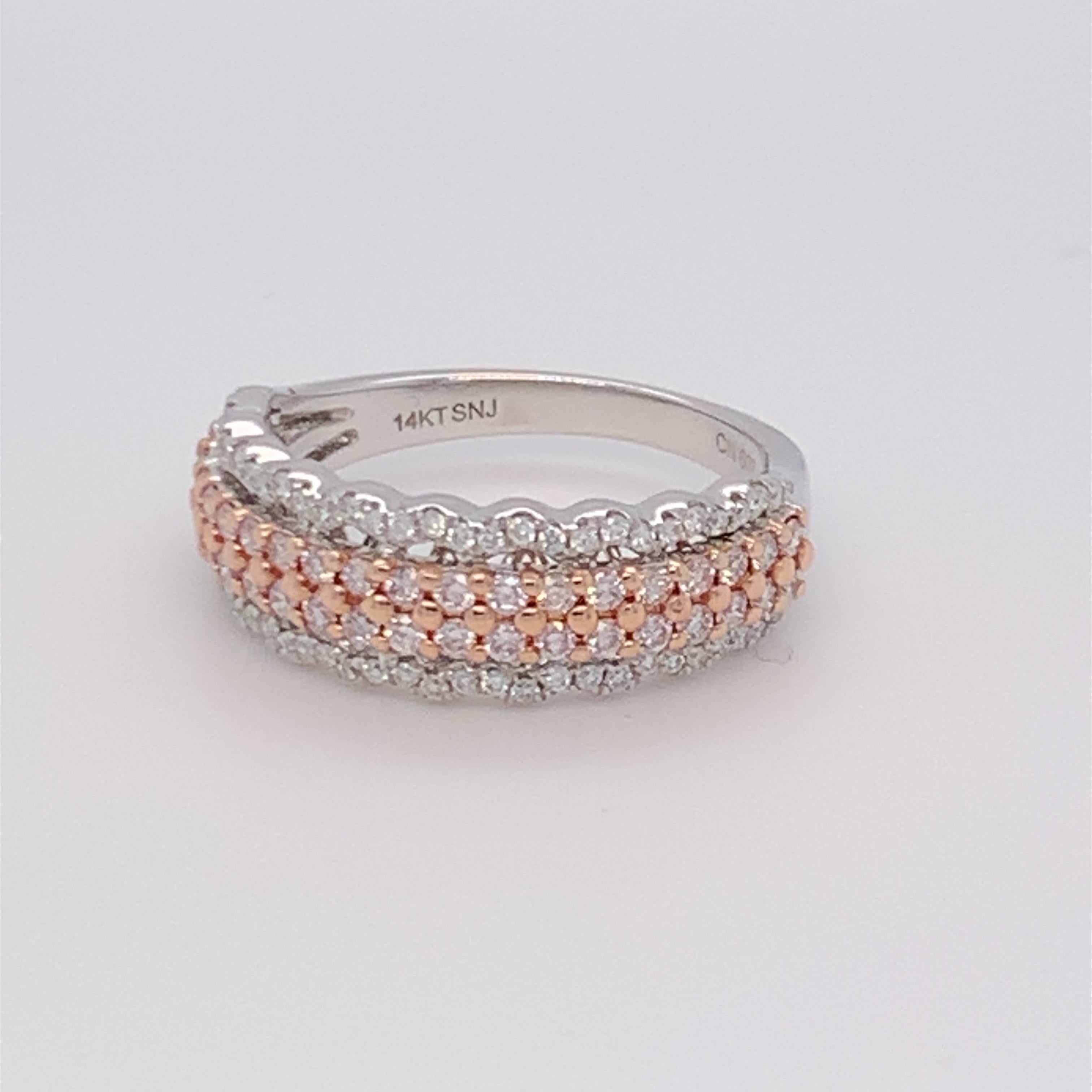 This stunning diamond ring has pink diamond band in between two rows of white diamonds. Carefully finished with hand by skilled craftsmen and mounted in 14K two tone gold.  
Pink Diamond: 0.46ct
White Diamond: 0.23ct
Gold: 14K Two Tone
Size: 7