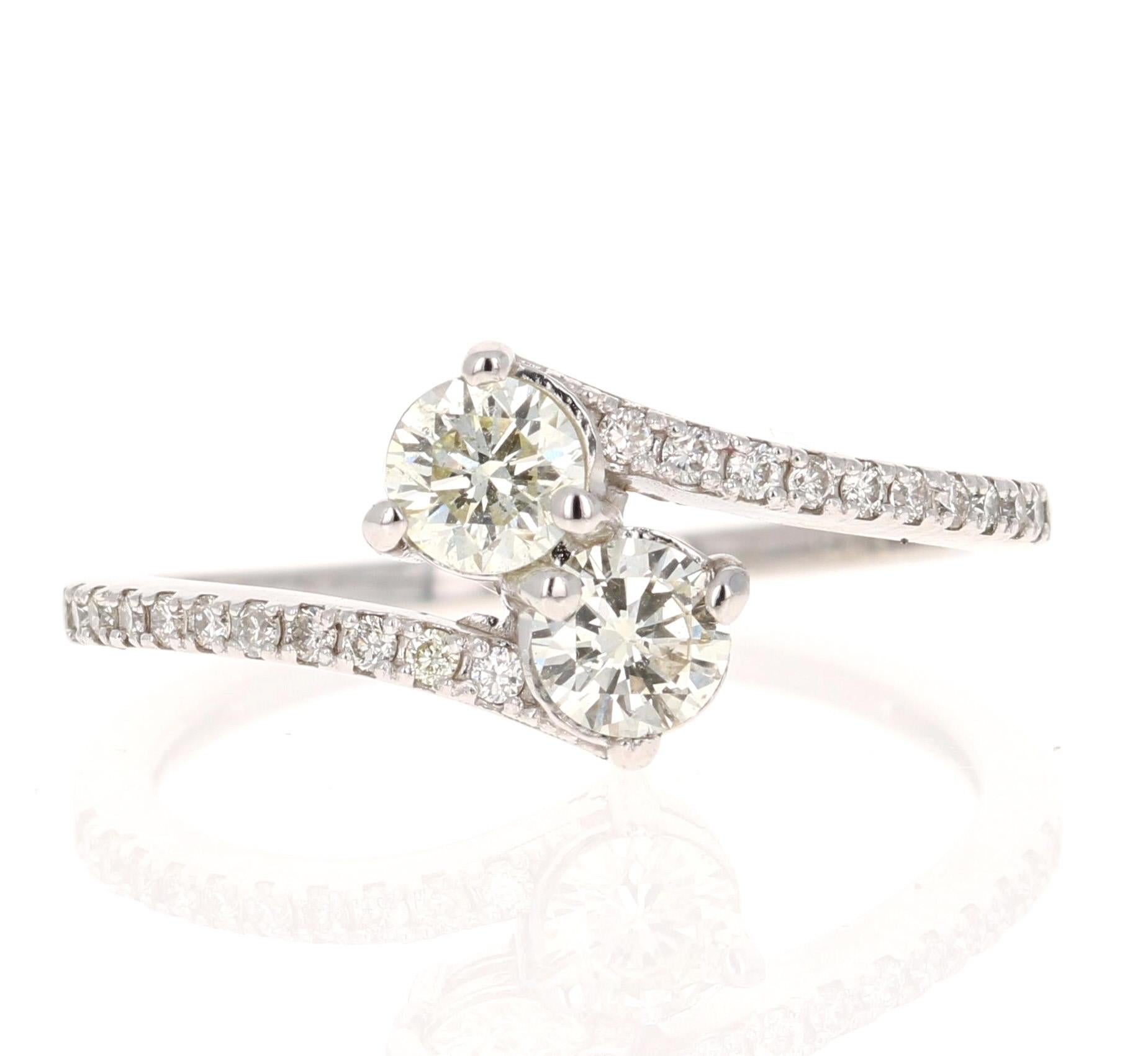 This ring features two Round Cut White Diamonds with a primary carat weight of 0.55 Carats and the surrounding diamonds have a secondary carat weight of 0.14 Carats. Both diamonds have a clarity of Slightly Included (SI1) and a color grade of J. The