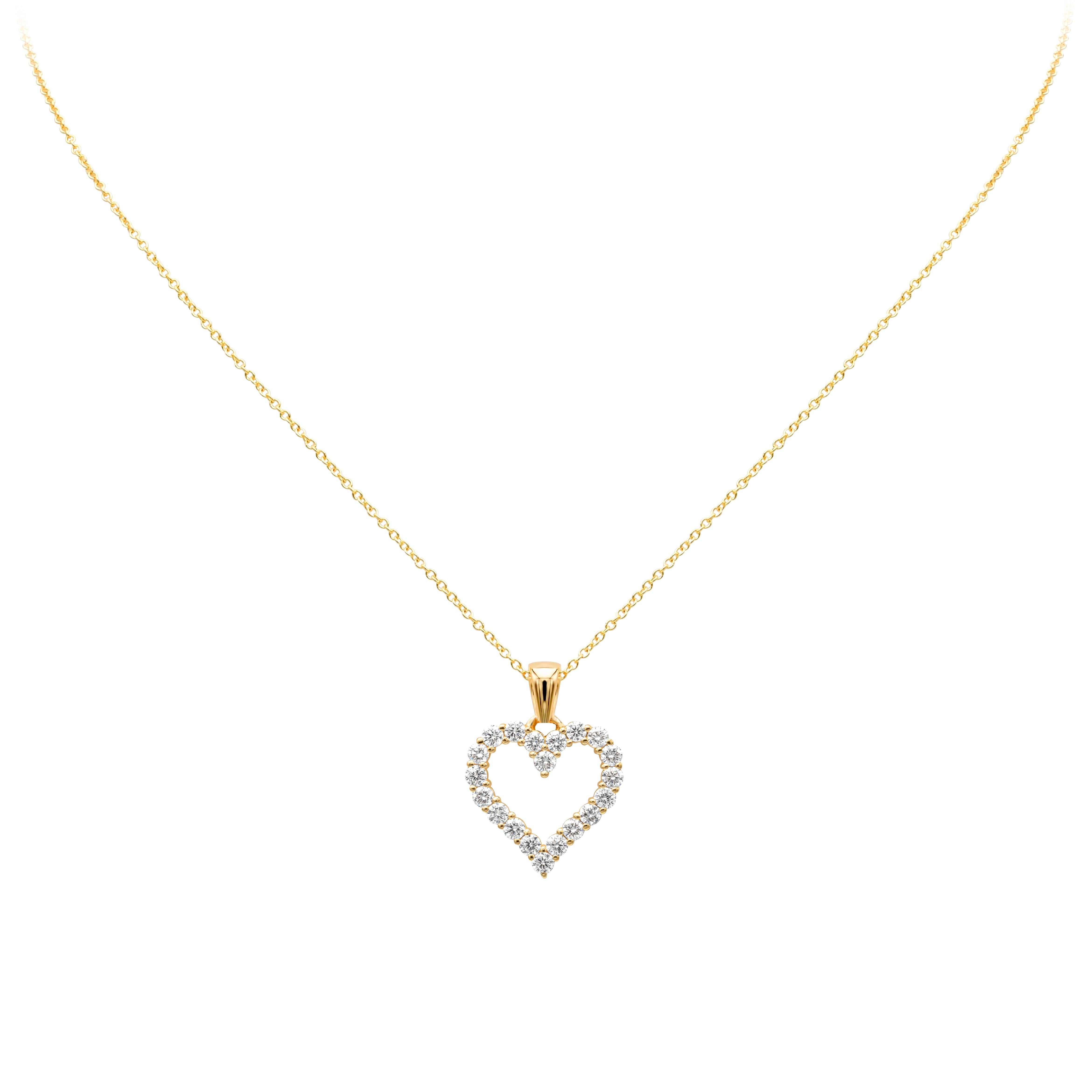 A simple and unique pendant necklace showcasing a row of round brilliant diamonds weighing 0.69 carats total, F color VS-SI1 clarity. Set in an open-work heart shape mounting made in 18K Yellow Gold and shared prong setting. Suspended on an