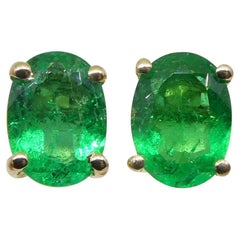 Used 0.6ct Oval Green Colombian Emerald Stud Earrings set in 14k Yellow Gold