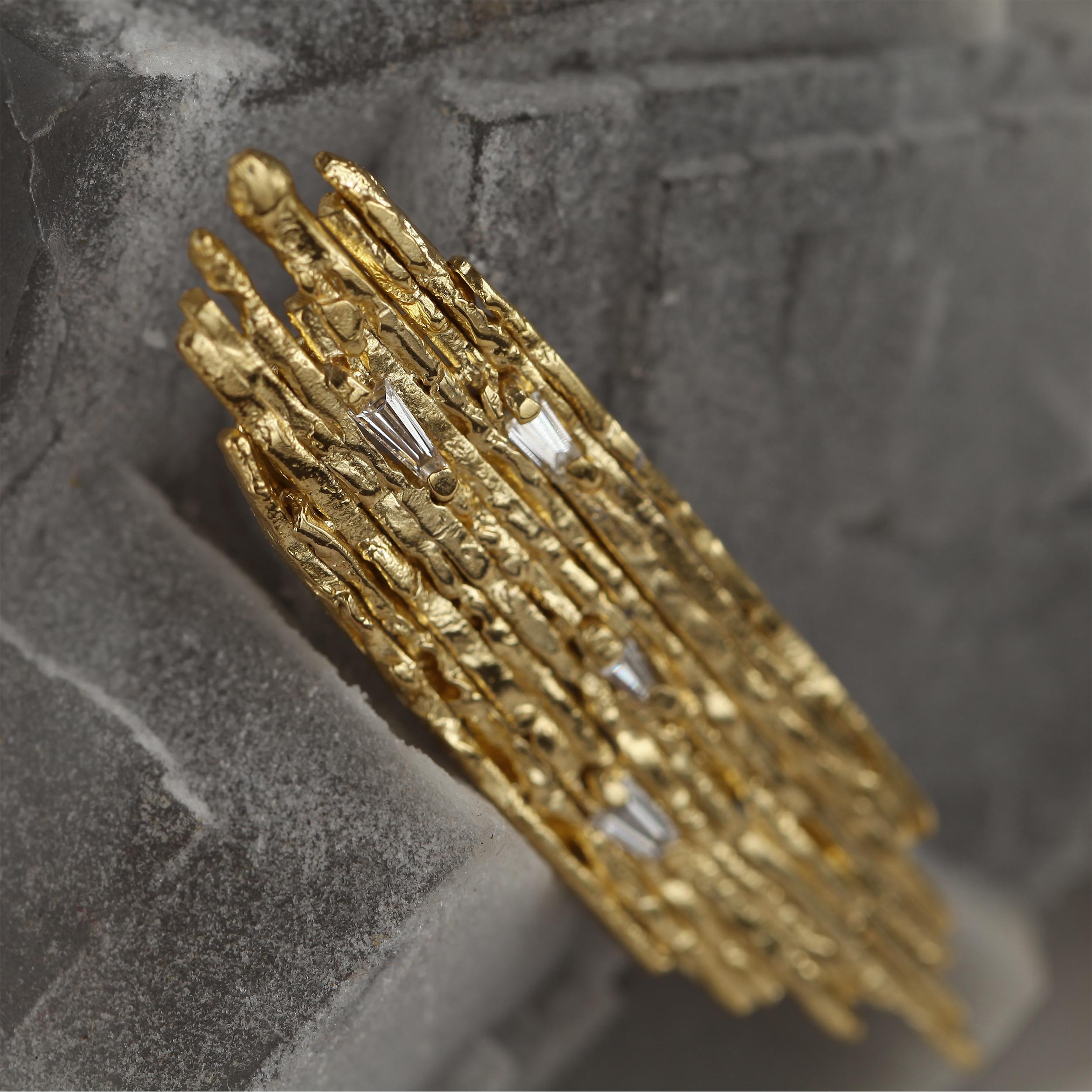Artfully handmade 0.7 Carat Tapered Baguette Diamond and 18k Yellow Gold Statement Brooch.

At the intersection of morphological study and eroded reliefs of antiquity, the Amorphe Brooch substantiates the geomorphic structure through the flow of
