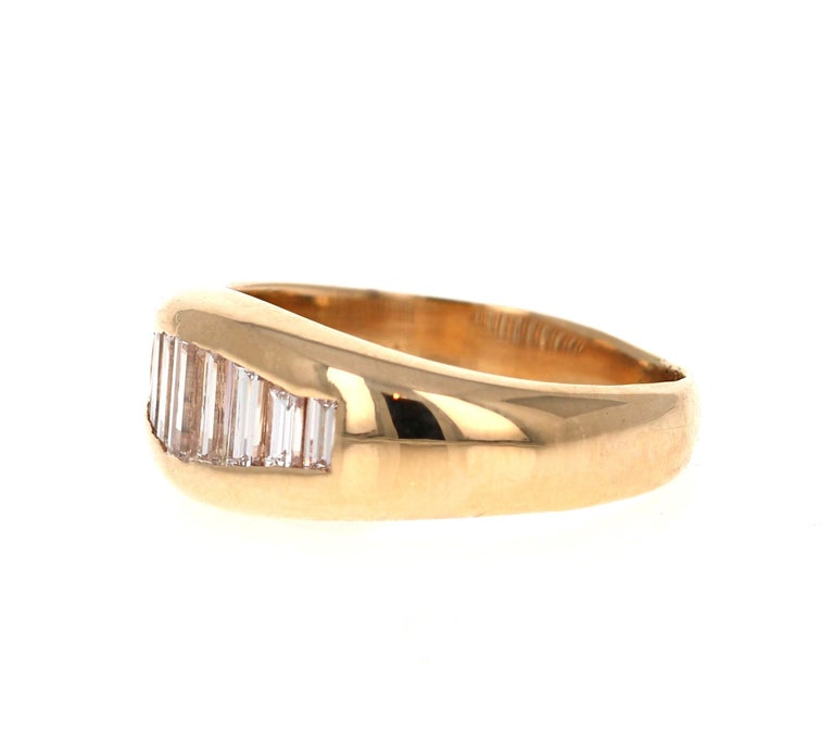 
This band has 9 Straight cut Baguette Diamonds that are all different in sizes weighing 0.70 Carats.  The total carat weight of the band is 0.70 Carats.  The Clarity and Color of the Diamonds are VS - I.

The ring is set in 18 Karat Yellow Gold and