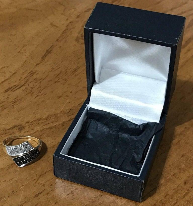 Wimbledon - Furniture are delighted to offer for sale for stunning black and white diamond 9 carat gold ring

The ring has x10 0.03 black diamonds totalling 0.30 carat, the white diamonds are just over 0.01 each and there are 40 of them so