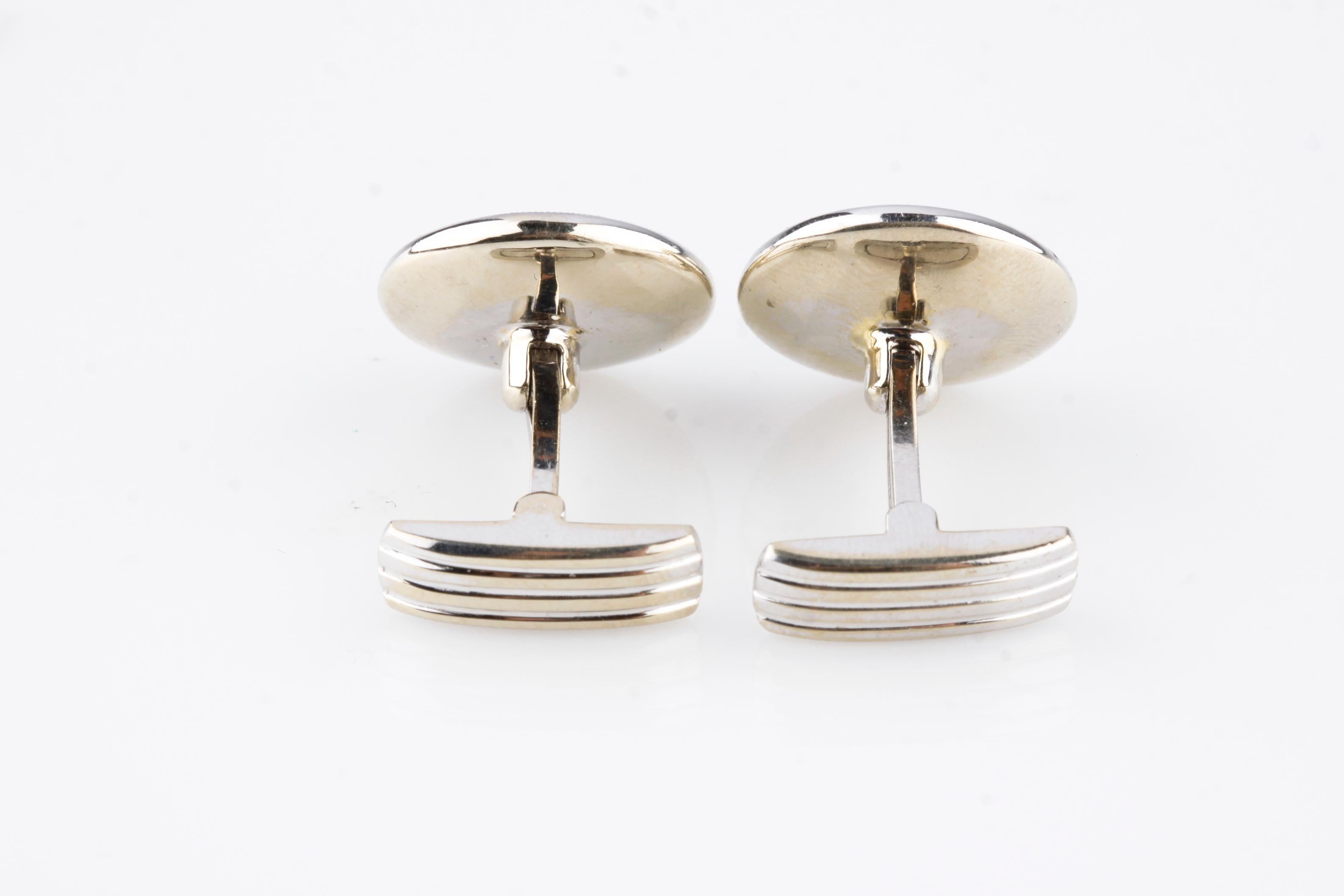 One pair electronically tested 14KT white gold gents cast & assembled cufflinks.
Condition is very good.
Each features a bezel set diamond solitaire set within an inner, inlay mother-of-pearl like bezel and an outer diamond bezel.
Bright polish