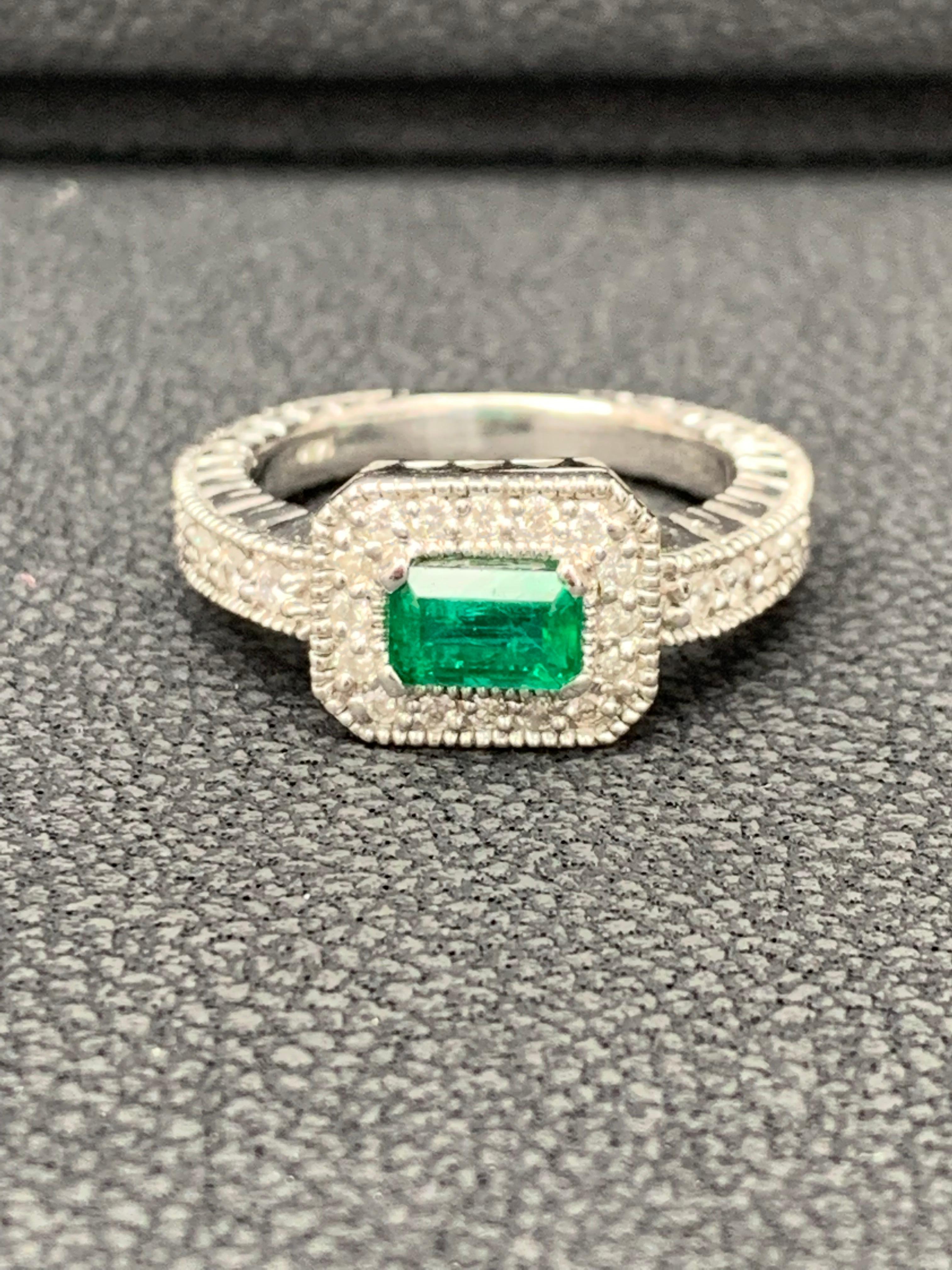 Featuring a 0.70 carat color-rich green emerald, elegantly set in an 14k white gold setting encrusted  round diamonds. Diamonds weigh 0.30 carats total.

Size 6.5 US (Sizable). One of a Kind  piece.
All diamonds are GH color SI1 Clarity.
Style