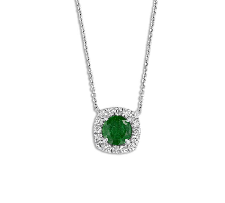 This beautiful pendant has a 6mm round cut emerald center (0.70 carats), surrounded by a halo of 1.5mm round white diamonds, total diamond weight 0.32 carats.
Set in 14k White Gold. The chain is attached.
Suggested retail price: $8,336

DiamondTown