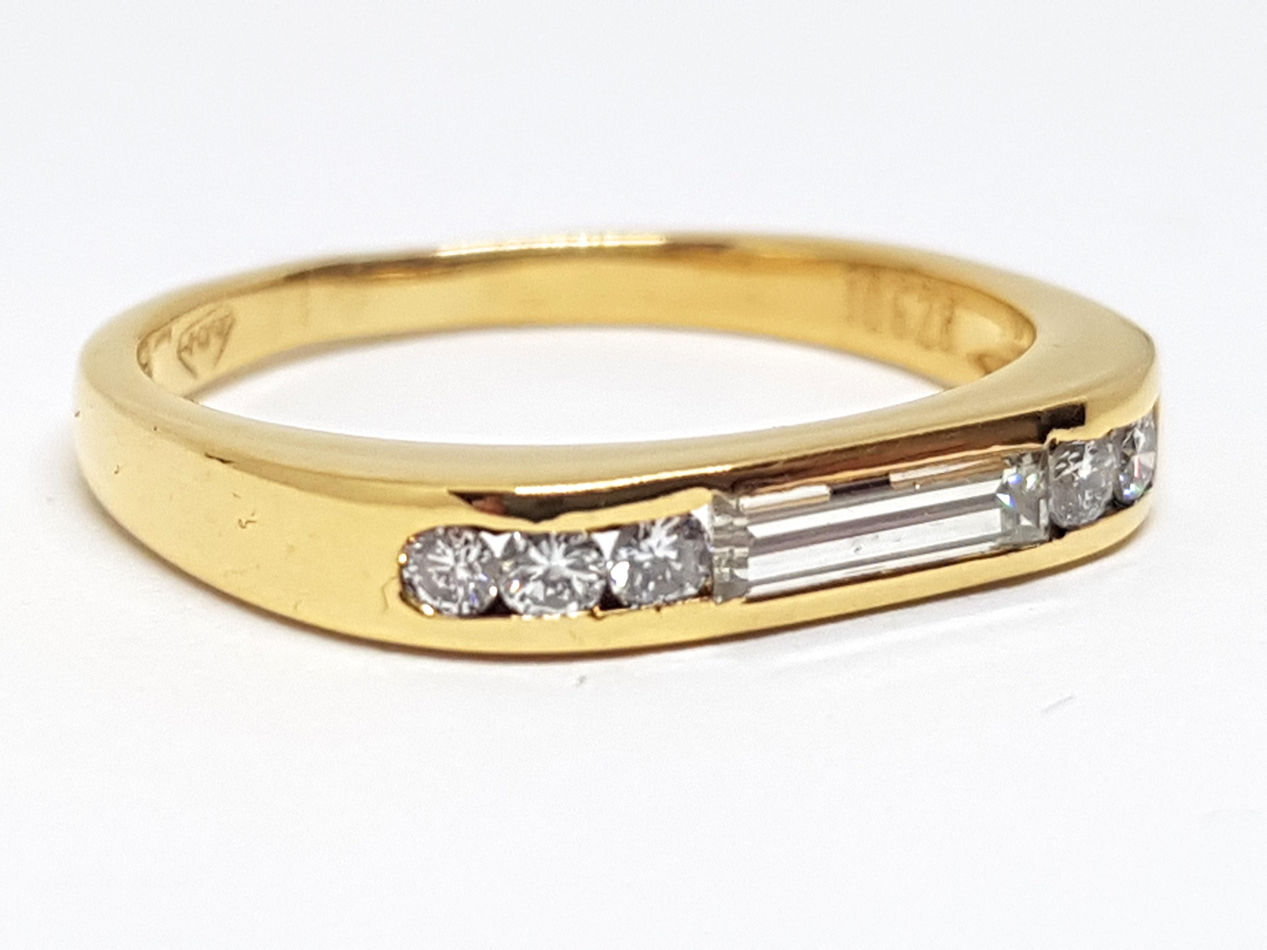 Gold: 18K Yellow Gold. 
Weight: 3,45 gr. 
Long Baguette: 0,40ct. F / VS 
Round Diamonds: 0,30ct. F / VS 
Width: 0,35 cm 
Ringsize: 54 / 17,25mm / US 7
Free resizing of ring up to size 70 / 22mm / US 13
Shipping: free worldwide insured shipping 
All