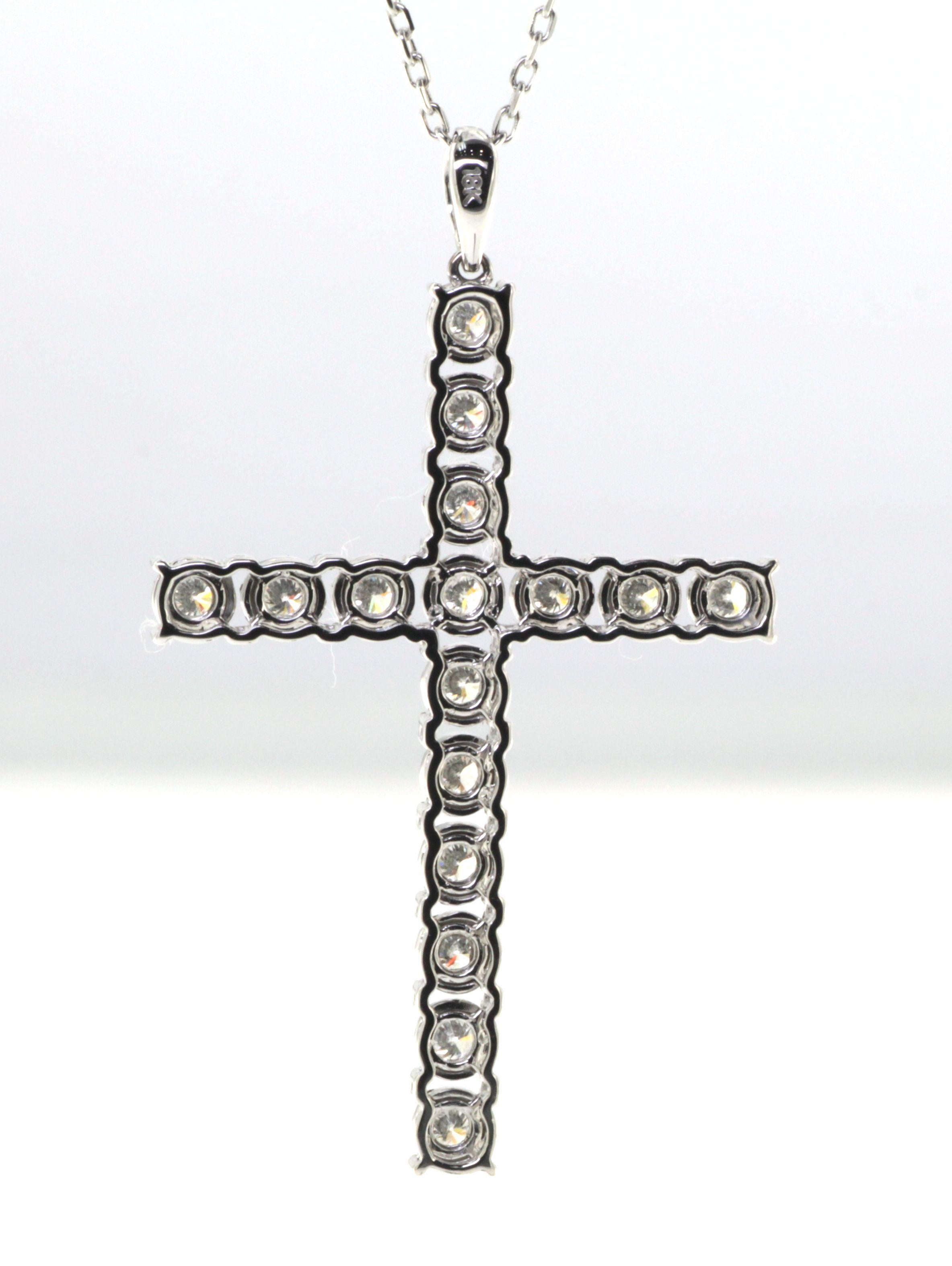 This cross pendant features 0.70 carats of  white round diamonds. Diamonds are set in illusion setting, it gives the diamonds a larger look. Pendant is set in 18 karat white gold, chain included. Chain is 17 inch. 

0.70 Carats White Round