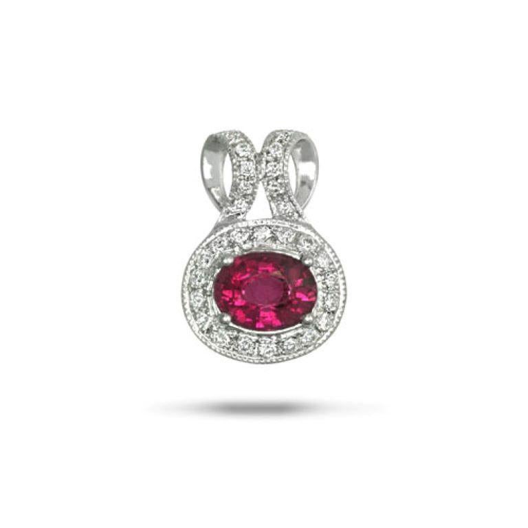 The elliptical setting of this 14K White Gold pendant prominently displays 0.70 carats of natural Rubellite and envelops it in spectacular white diamonds. While it may look delicate to the untrained eye, the setting offers strength and permanence,