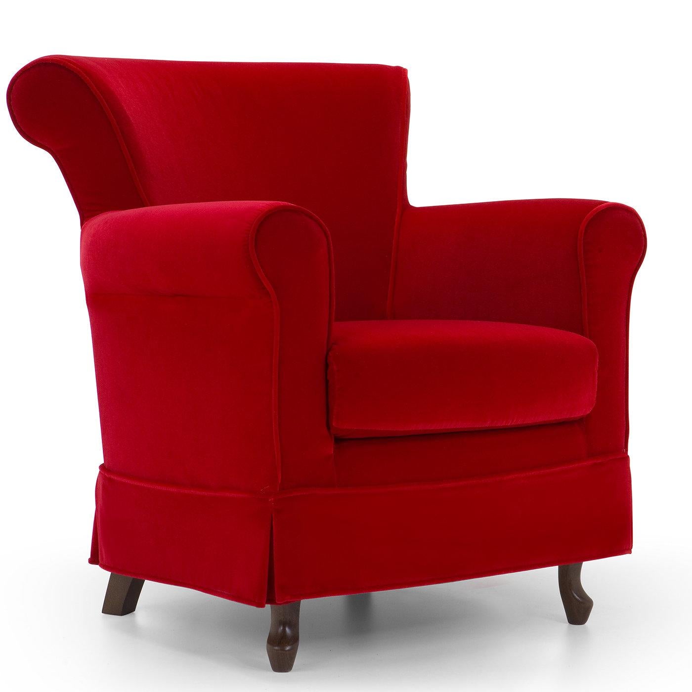 A sophisticated mix of traditional elegance and modern details, this armchair's imposing frame is entirely covered with a vivid red Dacron fabric. The injected flame-retardant polyurethane foam padding outlines the rolled backrest and armrests,