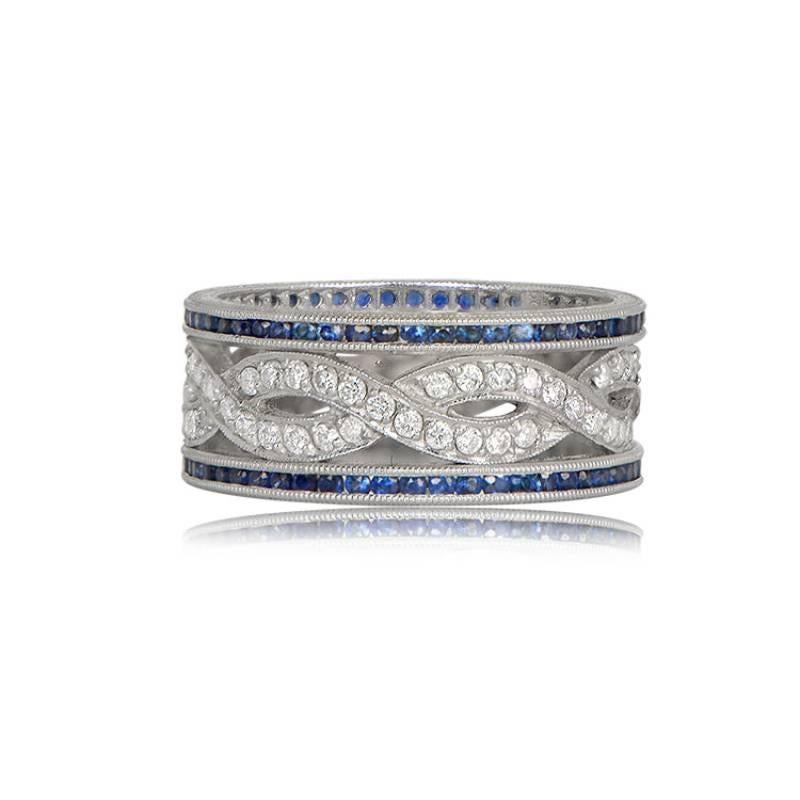 A stunning platinum wedding band, delicately designed with intertwined bands of brilliant-cut diamonds in the center. The sides are adorned with a border of royal blue Ceylon sapphires on each side, enhancing its beauty. The diamonds showcase