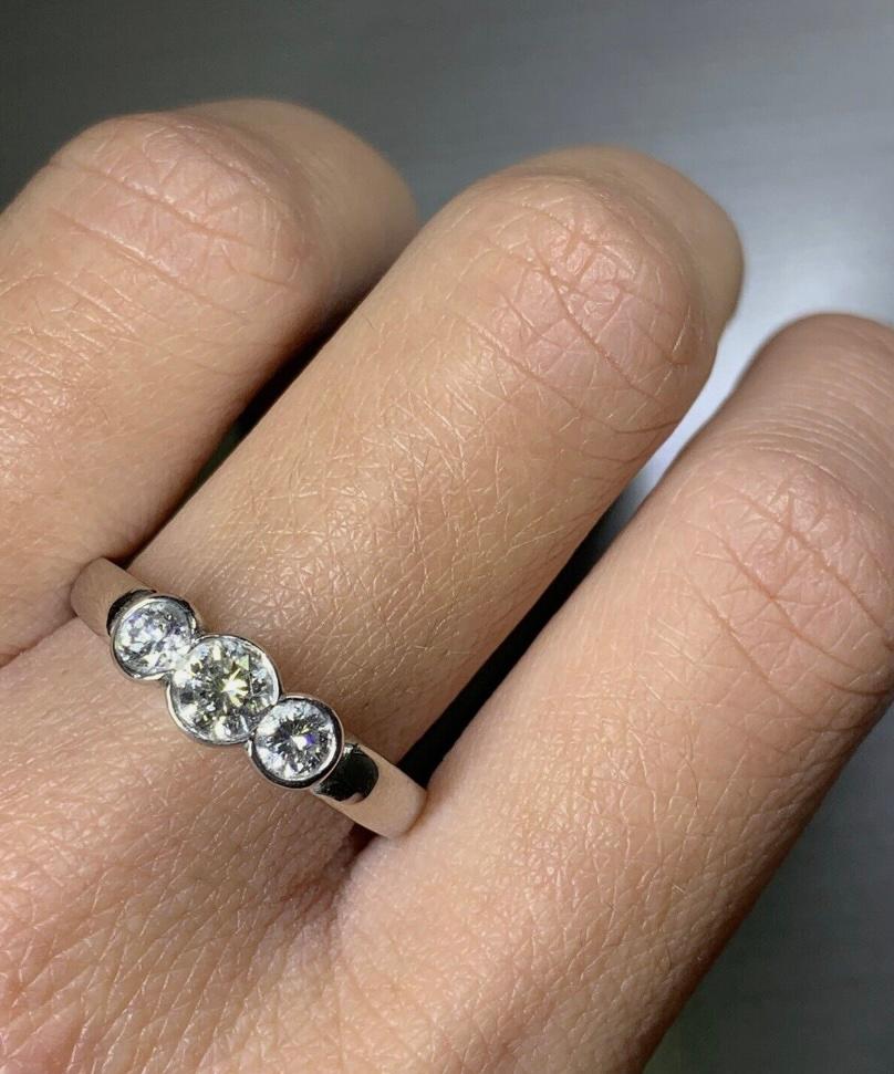 0.70ct round diamond trilogy engagement ring in platinum.

Classic three stone diamond ring trilogy style, bezel rubover setting dimaonds.

Trilogy ring total diamond weight 0.70ct G colour VS1 clarity

The ring can be resized

Hallmarked

Box and