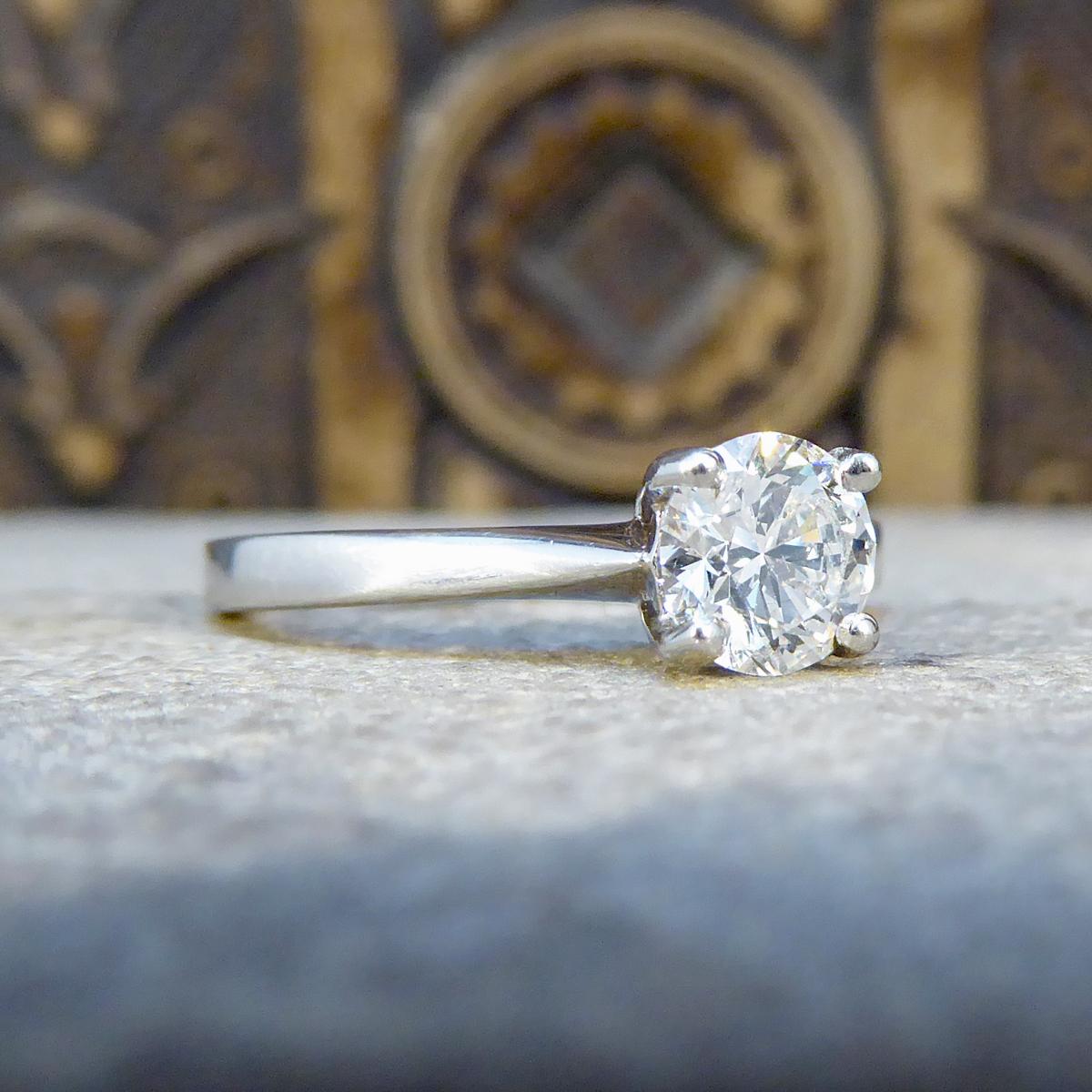 This beautifully sparkly engagement ring holds an Round cut Diamond weighing 0.70ct and is set in Platinum in an four claw setting. A classic solitaire ring with style that stands the test of time, the perfect engagement ring.

Diamond Details:
Cut: