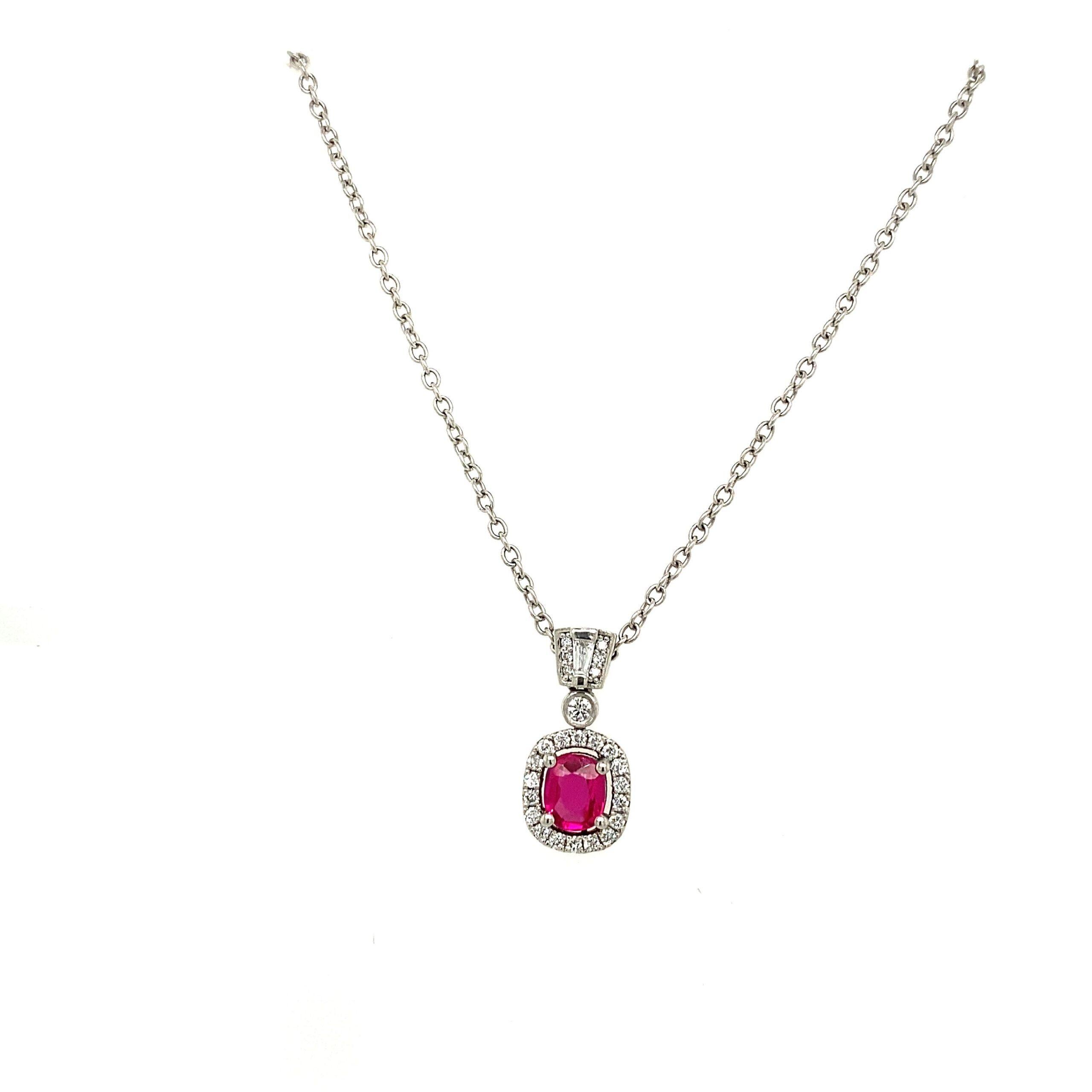 0.70ct Finest Quality Cushion Shape Ruby Pendant, Set with 0.42ct Of Diamonds

Surrounded by Round Brilliant Cut Diamonds  & One Tapered Baguette. Suspended on 14'' Platinum Trace Chain.

Additional Information:
Diamond Weight: 0.42ct
Diamond