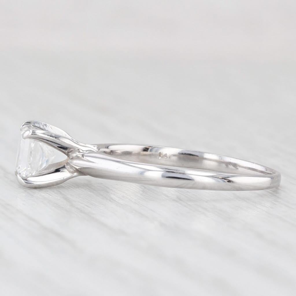 Gemstone Information:
- Natural Diamond -
Carats - 0.70ct 
Cut - Princess
Color - F
Clarity - VS1
IGI - 33549802

Metal: 14k White Gold
Weight: 2.1 Grams 
Stamps: 14k
Face Height: 5.8 mm 
Rise Above Finger: 8.1 mm
Band / Shank Width: 1.5 mm

This