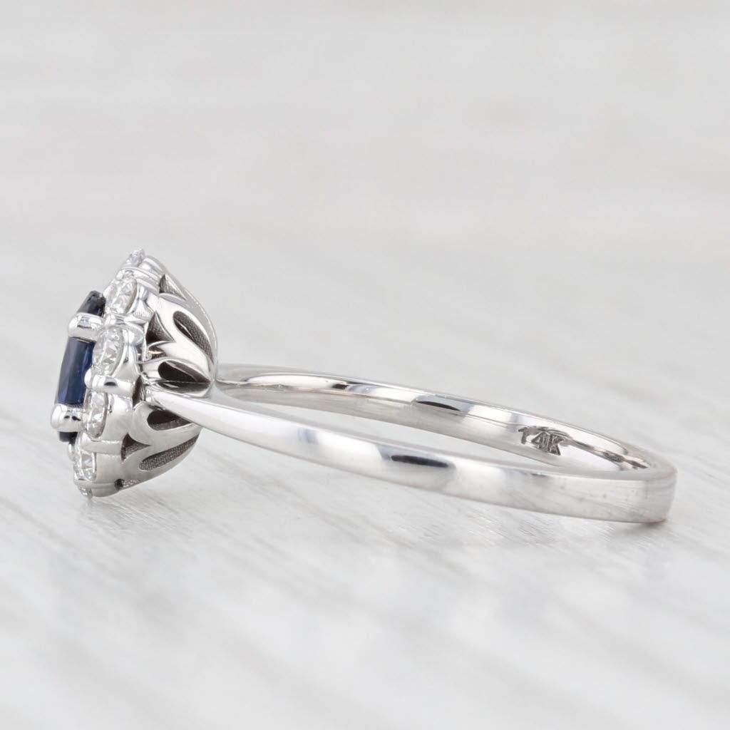 Gemstone Information:
- Natural Sapphire -
Carats - 0.40ct 
Cut - Oval Brilliant
Color - Dark Blue
Treatment - Heated

- Natural Diamonds -
Total Carats - 0.30ctw
Cut - Round Brilliant
Color - G - H
Clarity - SI1 - I1

Metal: 14k White Gold
Weight: