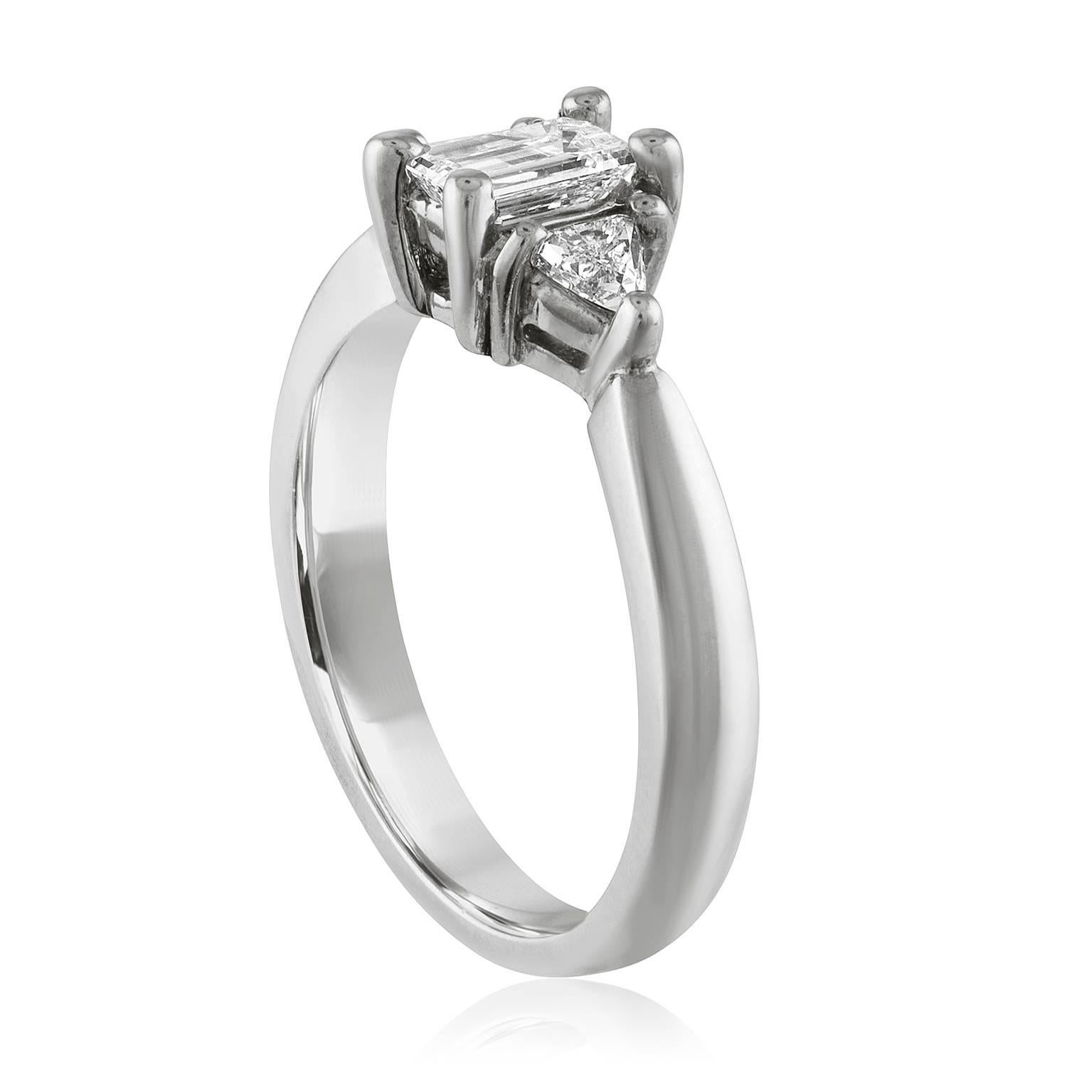 The ring is 14K White Gold
The Center stone is 0.45 Carats H VS Emerald Cut
The 2 Side stones are 0.26 Carats Total Weight H VS Trillions
All 3 diamonds total 0.71 Carats.
The ring weighs 3.9 grams
The ring is a size 6, sizable.