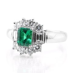 0.71 Carat Natural Emerald and Diamond Halo Ring Set in Platinum