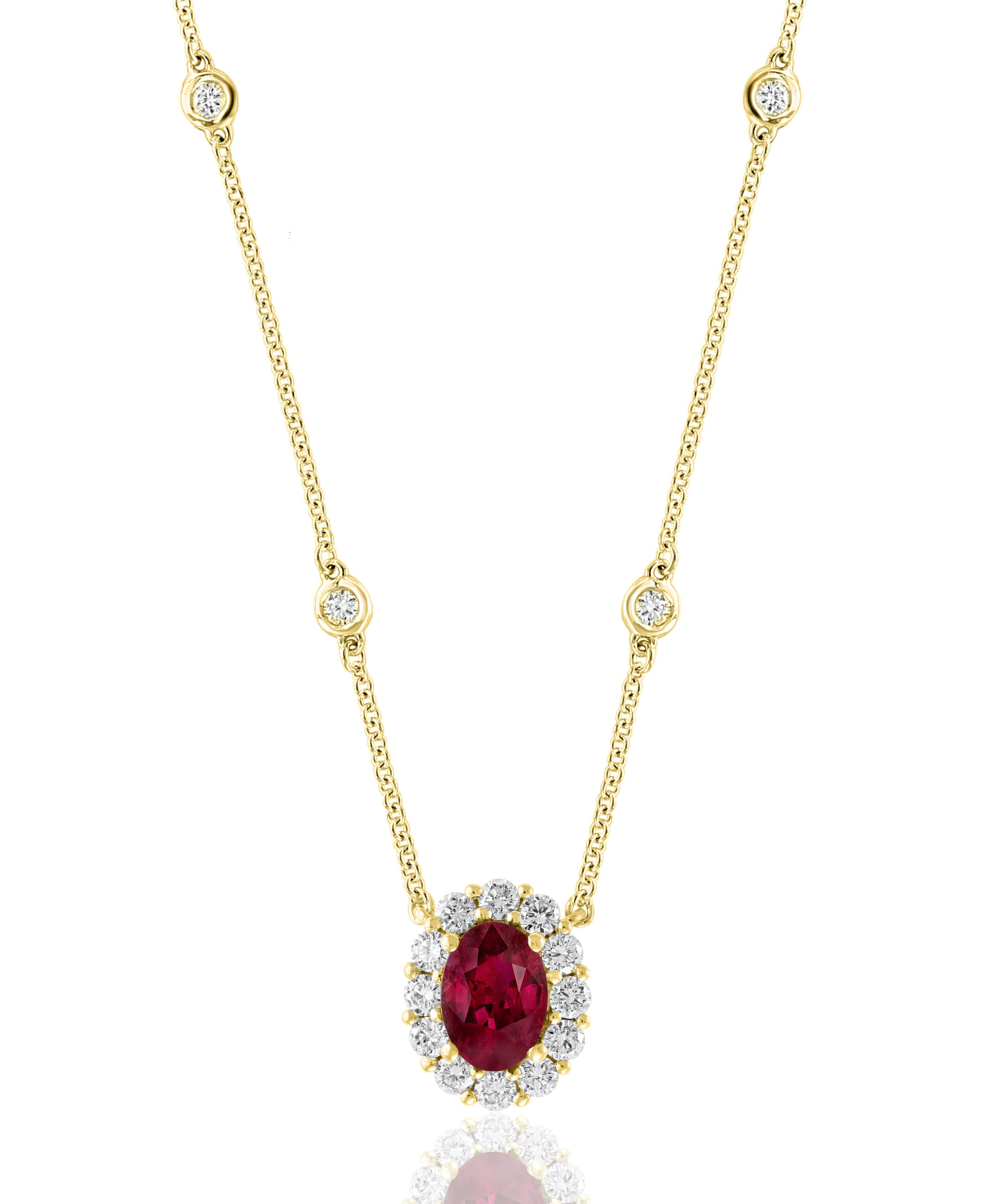 A fashionable pendant necklace showcasing a 0.71-carat oval cut ruby. The center stone is surrounded by a row of 16 brilliant-cut round diamonds weighing 0.48 carats in total. Made in 14k yellow gold. Comes with a gold chain accented with bezel-set