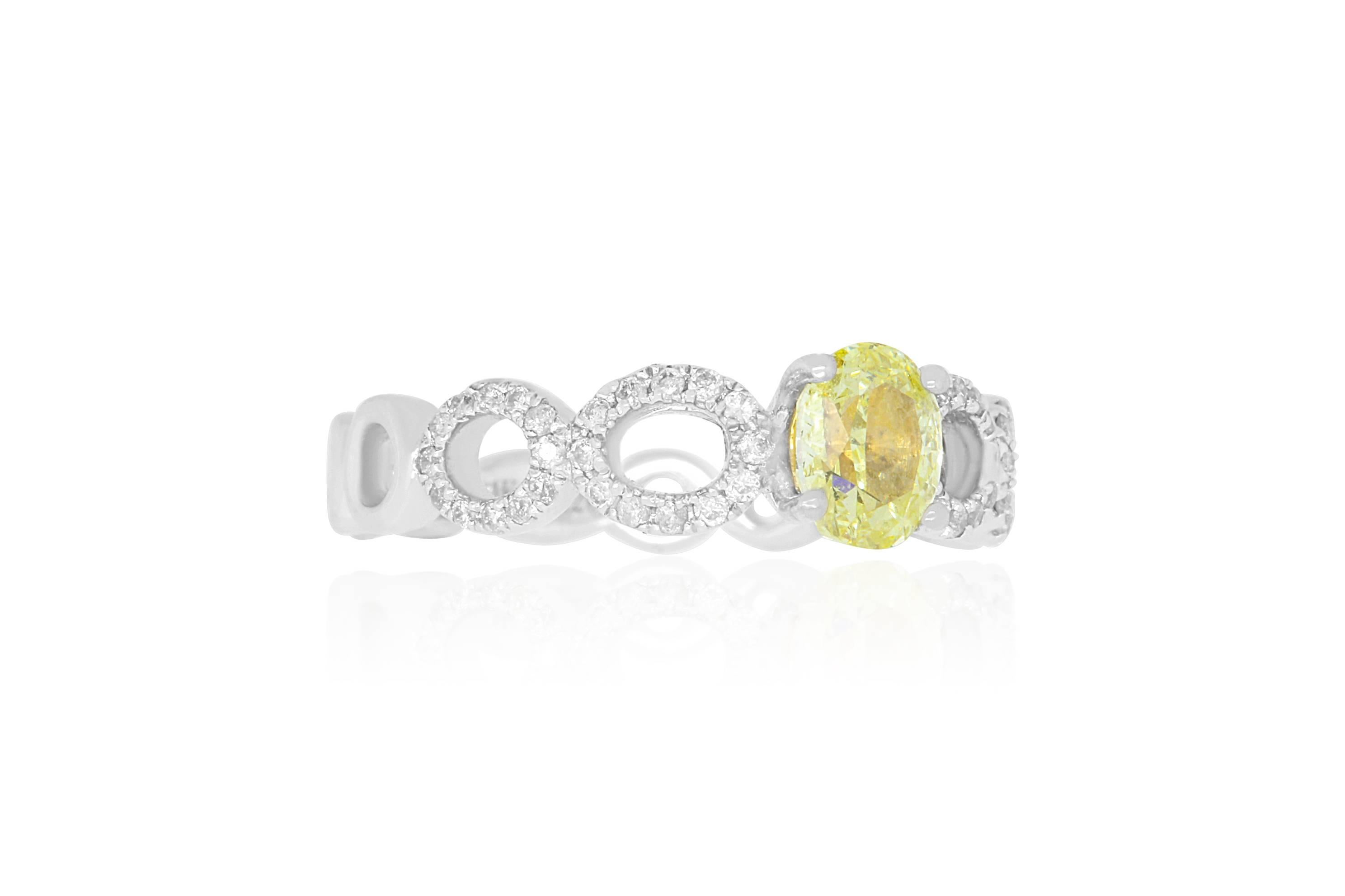 Material: 14K White Gold 
Center Stone Details: 1 Oval Shaped Yellow Diamond at 0.71 
Stone Details: Round White Diamonds at 0.20 Carats - Clarity: SI  / Color: H-I
Ring Size: Size 5.5. Alberto offers complimentary sizing on all rings.

Fine