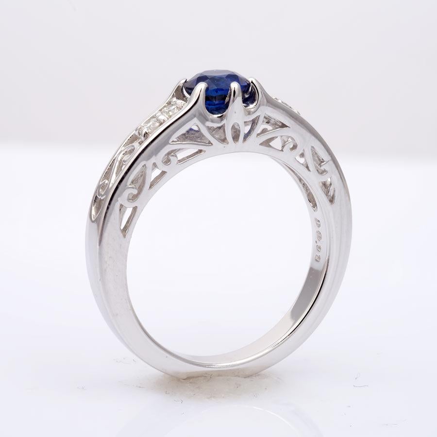 Set with a natural Sapphire, this ring is truly one of a kind. With diamond accents the rings floral design is very captivating and will have her wanting one in minutes. Crafted in 14K white gold the ring uses strong prongs to hold each gem in